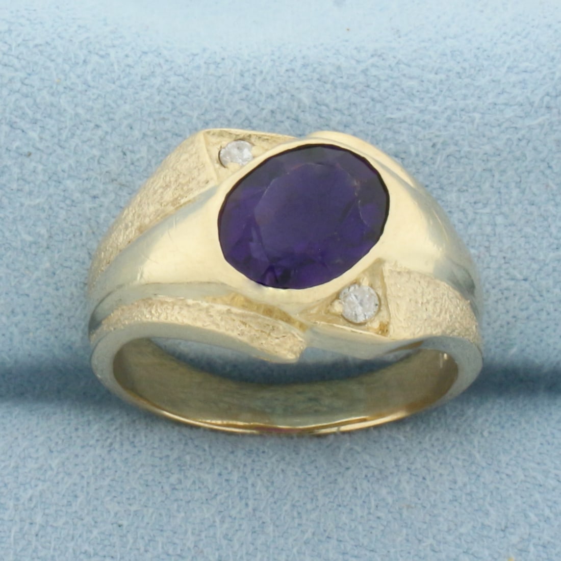 Amethyst and Diamond Ring in 14k Yellow Gold: In 14k Yellow Gold. Contains one 10x8mm high quality oval cut natural Amethyst gemstone, approximately 2.5cts, with intense color and excellent clarity. Also contains two high quality .04ct diamonds.