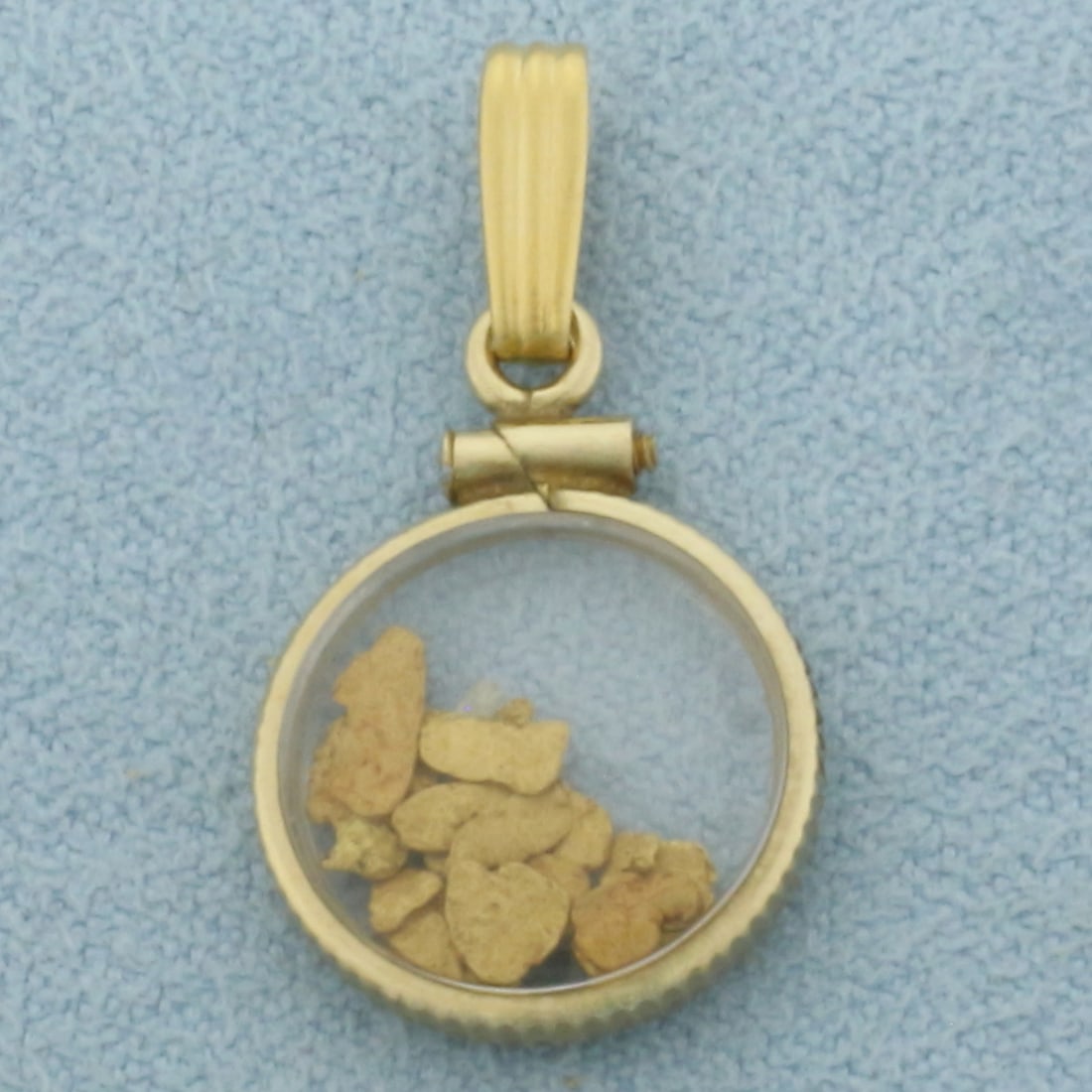 24k Gold Flakes Pendant in 10k Yellow Gold: In 10k Yellow Gold. 1 inch long (including bale). 24k gold flakes. 1/2 inch wide. 1.2g.