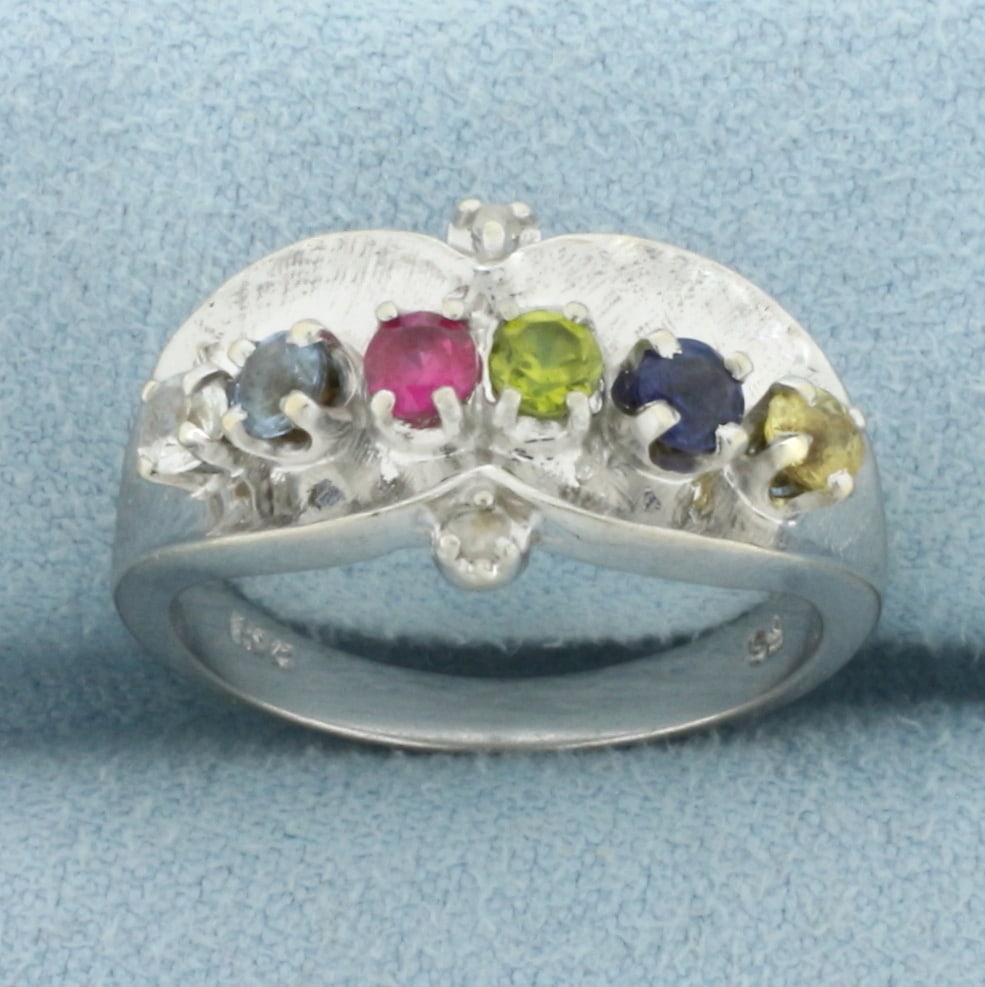 Multi Gemstone and Diamond Ring in 10k White Gold: In 10k White Gold. Contains 3mm high quality Ruby, Sapphire, Topaz, and Spinel gemstones with vibrant color an excellent clarity. Also contains two high quality 1/2pt diamonds. 11mm wide at center. Si