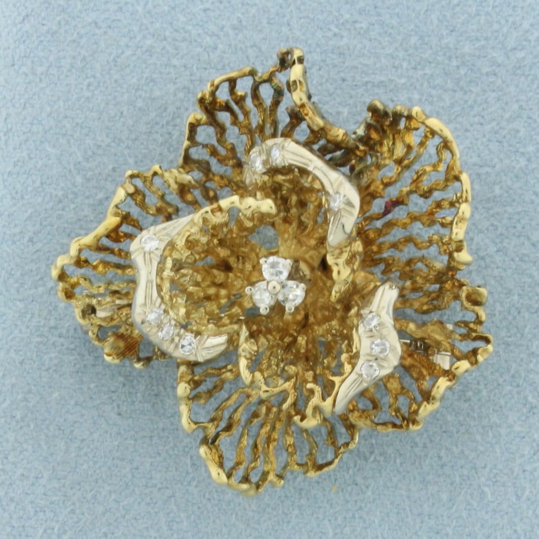 Italian Designer Flower Brooch in 18k Yellow Gold: In 18k yellow gold. Contains thirteen high quality diamonds, 1/4ct TW, VS clarity/H color . 1 1/4 inches wide and 1 1/4 inches long. 12.7g.