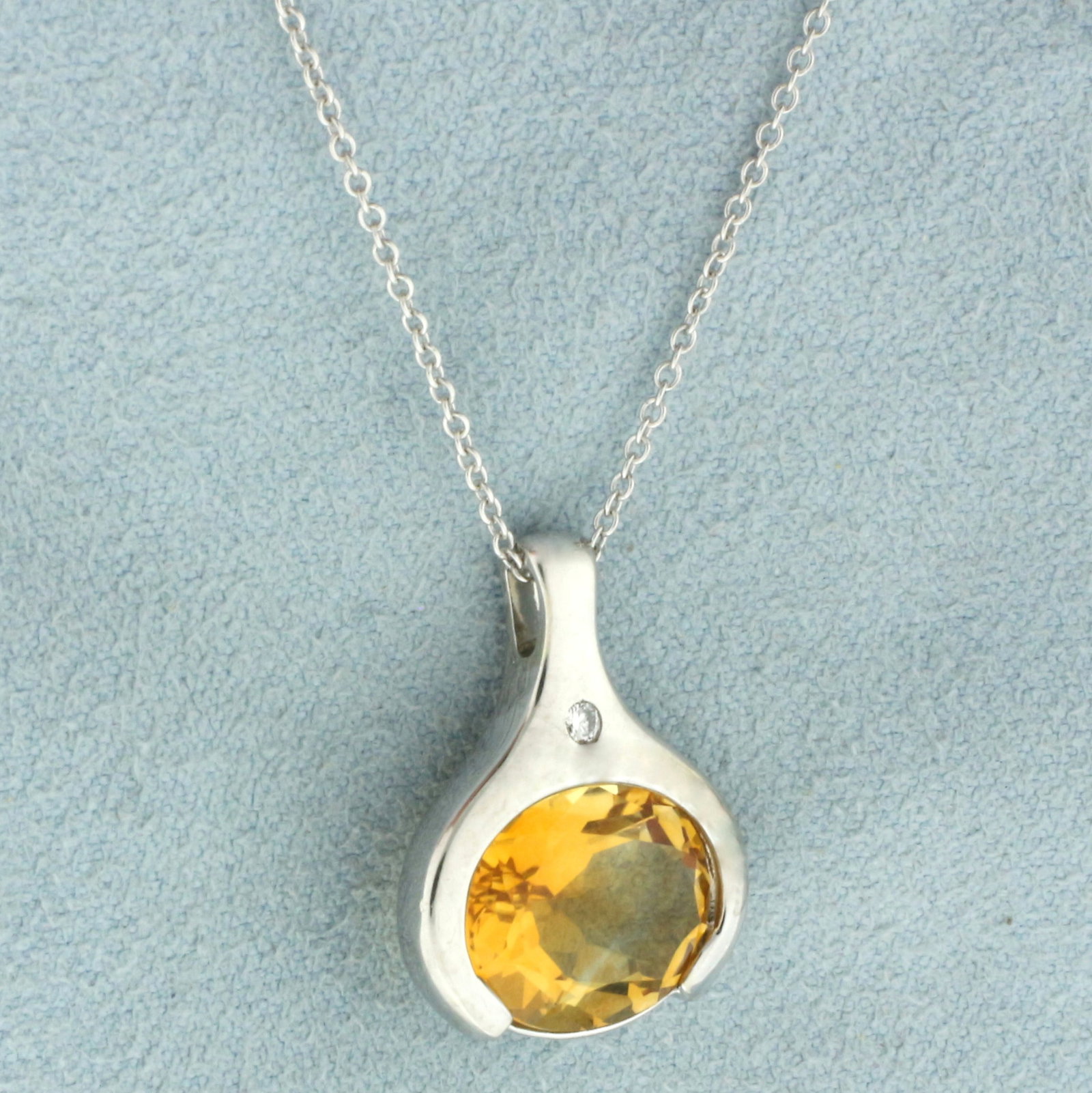 Citrine and Diamond Necklace in 14k White Gold: In 14k white gold. Contains one high quality natural 4.5ct Citrine gemstone with excellent clarity and desirable vibrant yellow orange color. Also contains one high quality .02ct diamond, VS clarity/G