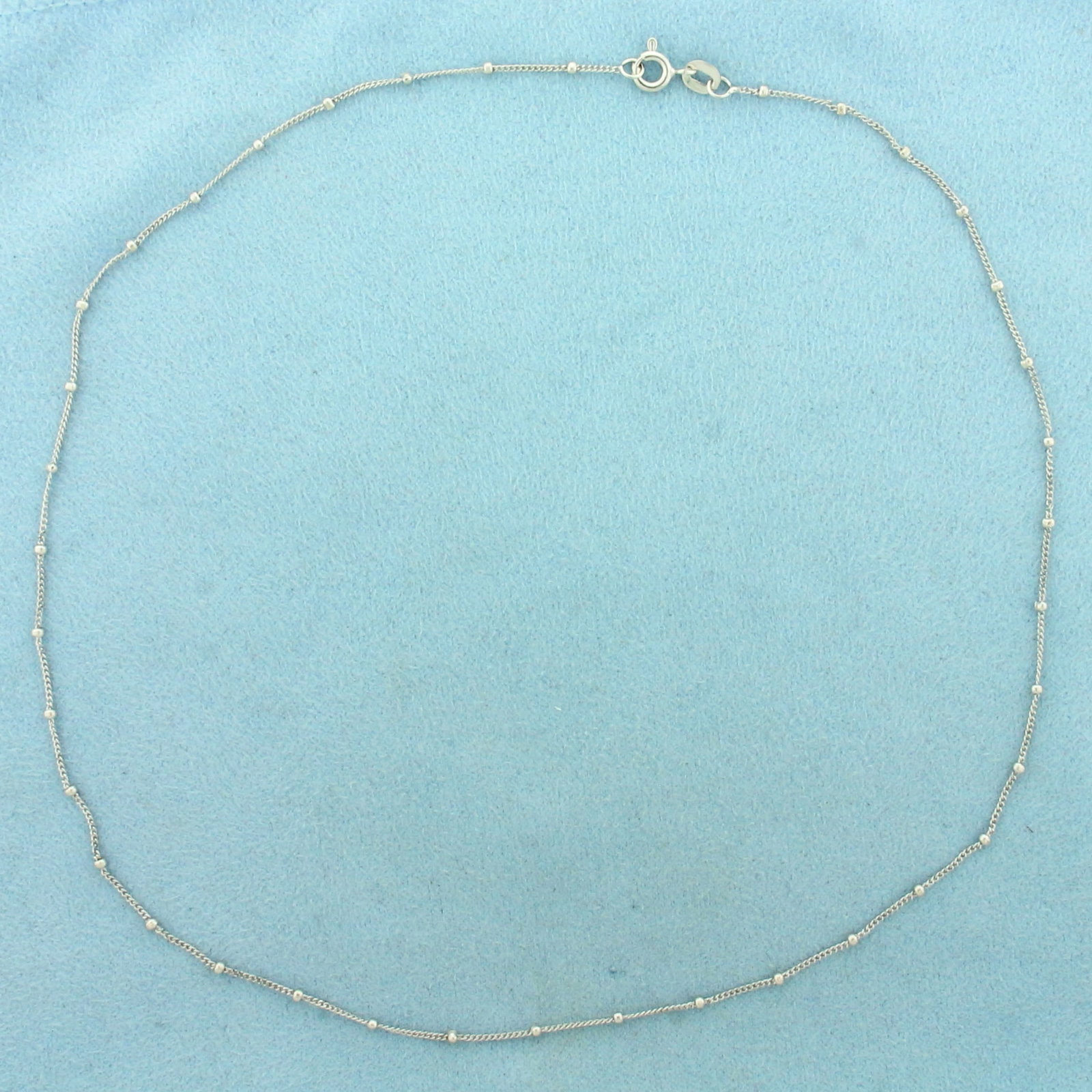 16 Inch Curb Link Ball Bead Station Necklace in 18k White Gold: In 18k White Gold. 16 inches long. 1.5mm ball beads. Spring clasp. 2.3g.