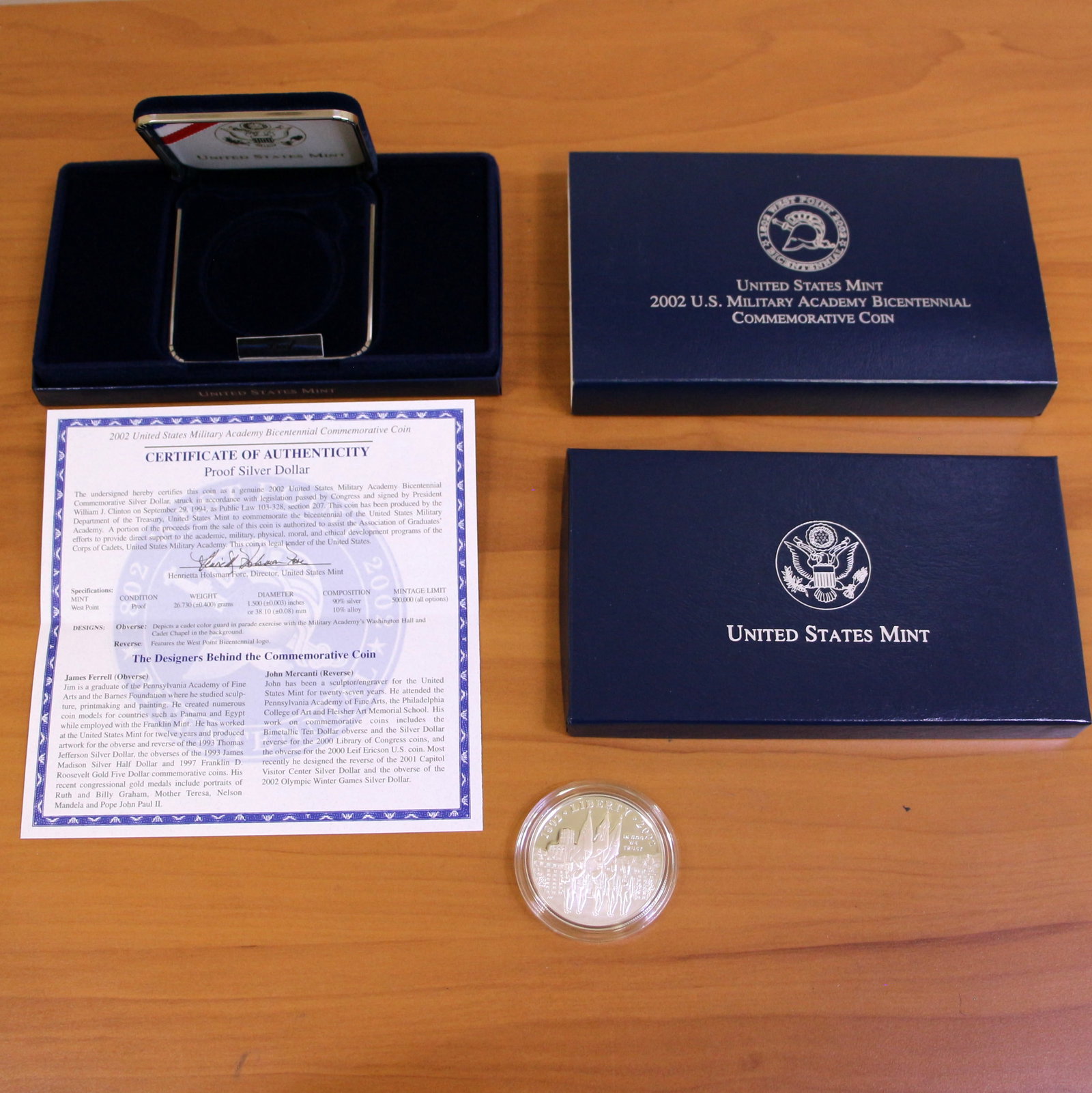 US Mint 2002 United States Military Academy Silver Dollar Coin OGP: Contains one 2002 United States Military Academy Bicentennial Commemorative 90% Silver Dollar. Set in original government packaging and contains certificate of authenticity.