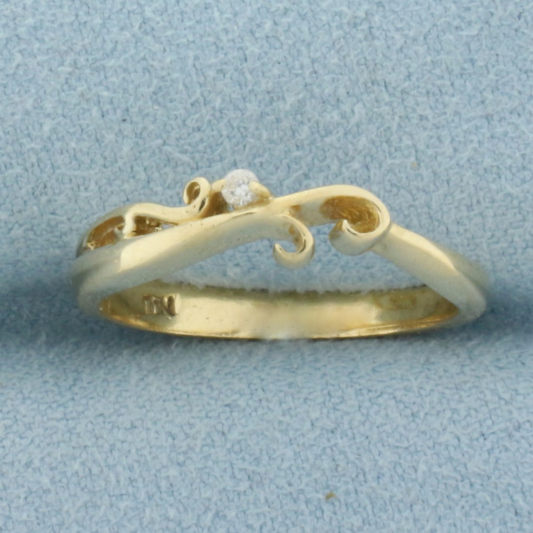 Diamond Scroll Stacking Band Ring in 14k Yellow Gold: In 14k Yellow Gold. Contains one .02ct high quality diamond, SI clarity/H color. 4.3mm wide at widest spread. Size 7.5. 2.9g.