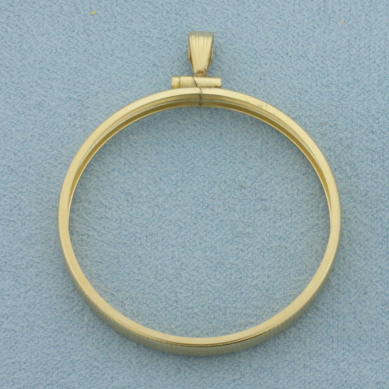 31mm Coin Bezel Pendant in 14k Yellow Gold: In 14k Yellow Gold. 1 5/8 inch long (including bale). 1 1/4 inch diameter. Fits any 31mm coin like a 1oz Maple Leaf. 2.5g.
