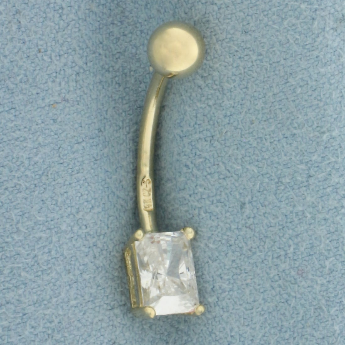 CZ Belly Ring in 14k Yellow Gold: In 14k Yellow Gold. Contains one 5x7mm high quality radiant cut Cubic Zirconia gemstone with excellent cut and clarity, approximately 1ct. 1.1g.
