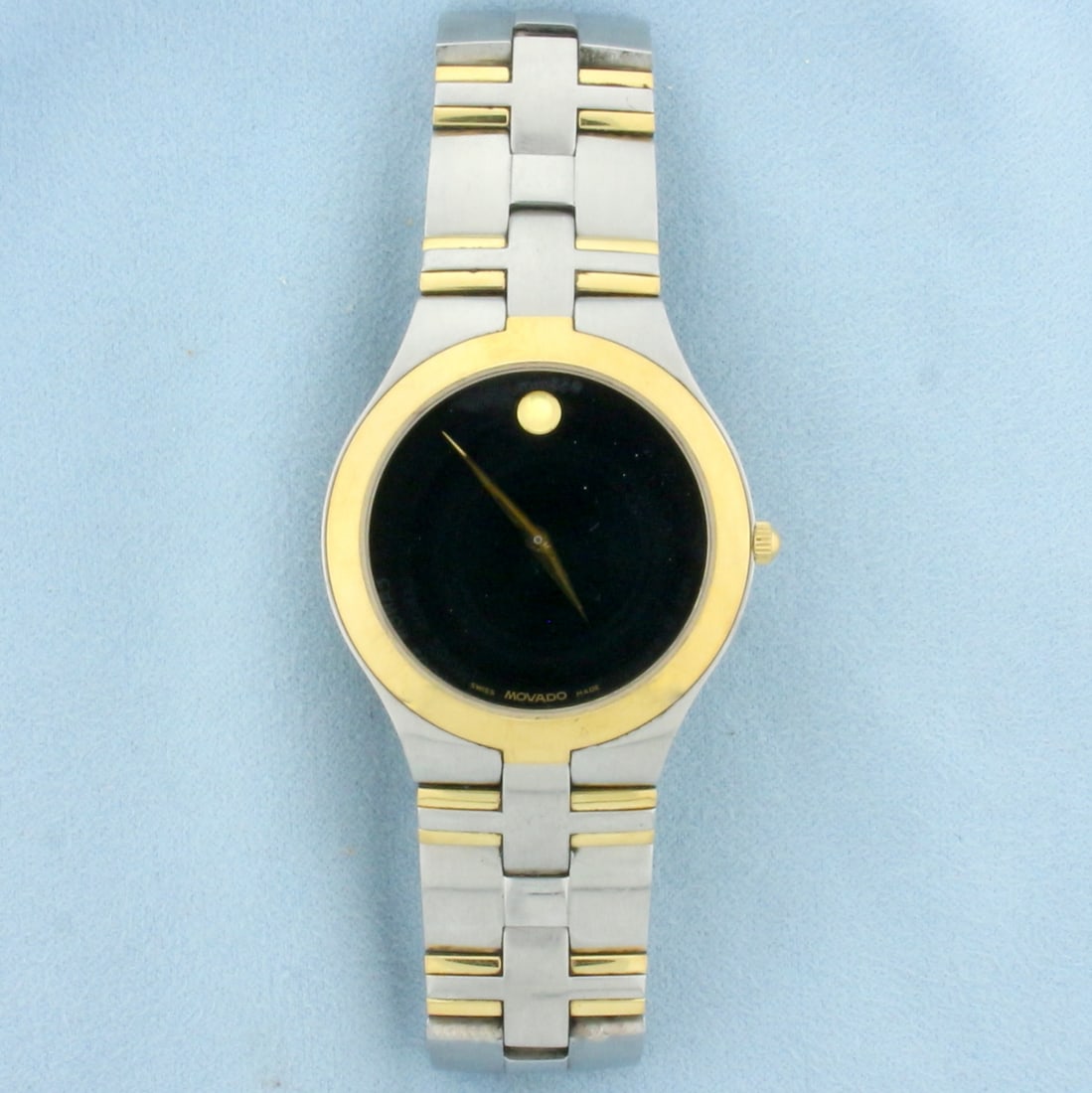 Men's Movado Two Tone Watch: In Stainless Steel. 40mm case. Black dial. Quartz movement runs great, new battery. Overall great condition, no scratching on crystal.