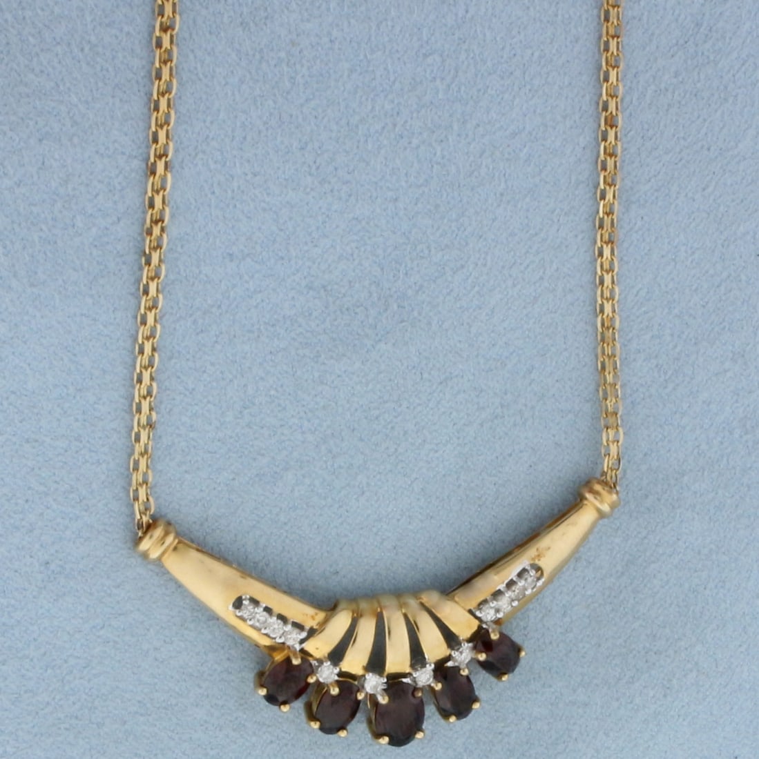 Vintage Garnet and Diamond Necklace in 14k Yellow Gold: In 14k yellow gold. Contains four 1/2ct and one 1ct high quality natural Garnet gemstones with intense color and excellent clarity. Also contains twelve high quality diamonds, 1/4ct TW, SI clarity/H