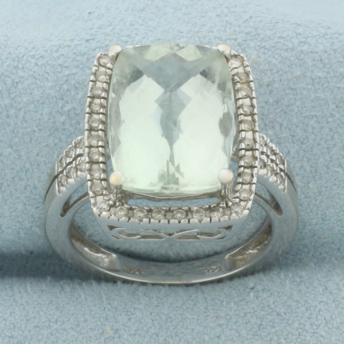 Aquamarine and Diamond Halo Ring in 14k White Gold: 14k White Gold. Contains one high quality natural checkerboard cushion cut Aquamarine gemstone, 14mm x 10mm, 7cts, excellent clarity, bright color. Also contains forty four high quality diamonds,