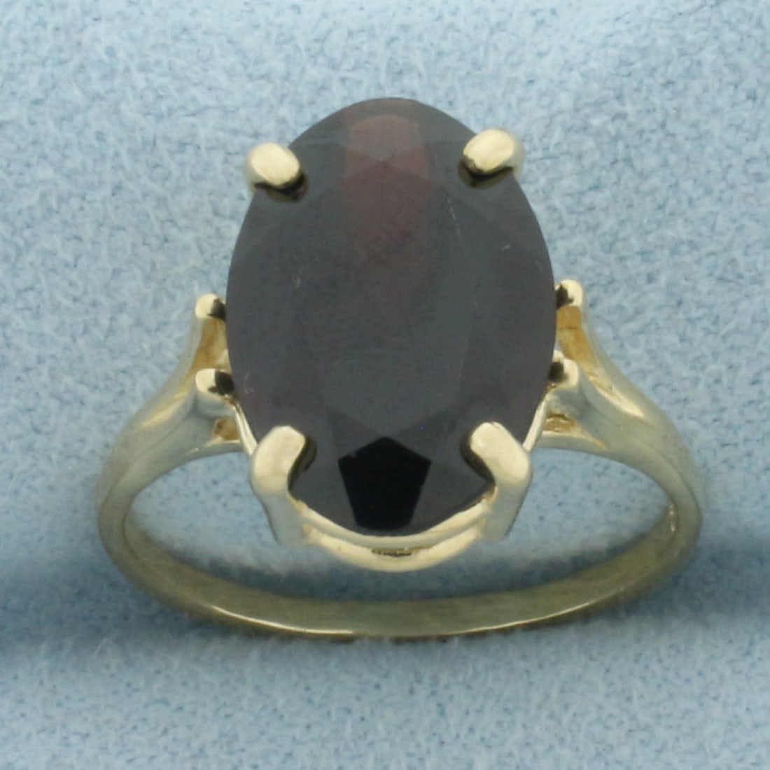 Garnet Solitaire Statement Ring in 14k Yellow Gold: In 14k Yellow Gold. Contains one high quality natural 14mm x 10mm Garnet gemstone with deep color and excellent clarity. Size 6.5. 3.7g.