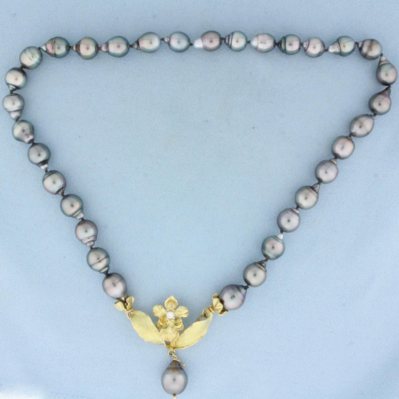 Designer Angela Conty Tahitian Pearl and Diamond Necklace in 18k Yellow Gold: In 18k Yellow Gold. Contains one high quality .10ct diamond, VS clarity/G color. 18 inches long. Contains 9mm to 11mm high quality baroque Tahitian pearls with high luster and beautiful peacock