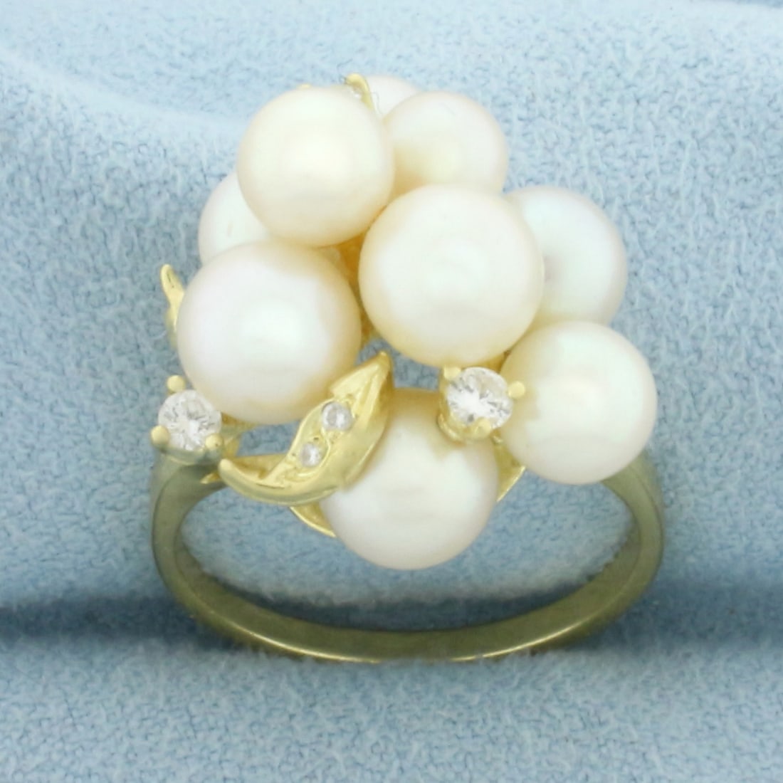 Cultured Akoya Pearl and Diamond Ring in 18k Yellow Gold: In 18k Yellow Gold. Contains nine high quality 5 to 6.5mm cultured Akoya pearls with high luster. Also contains seven high quality diamonds, 1/4ct TW, VS clarity/H color. 20mm wide at widest point.