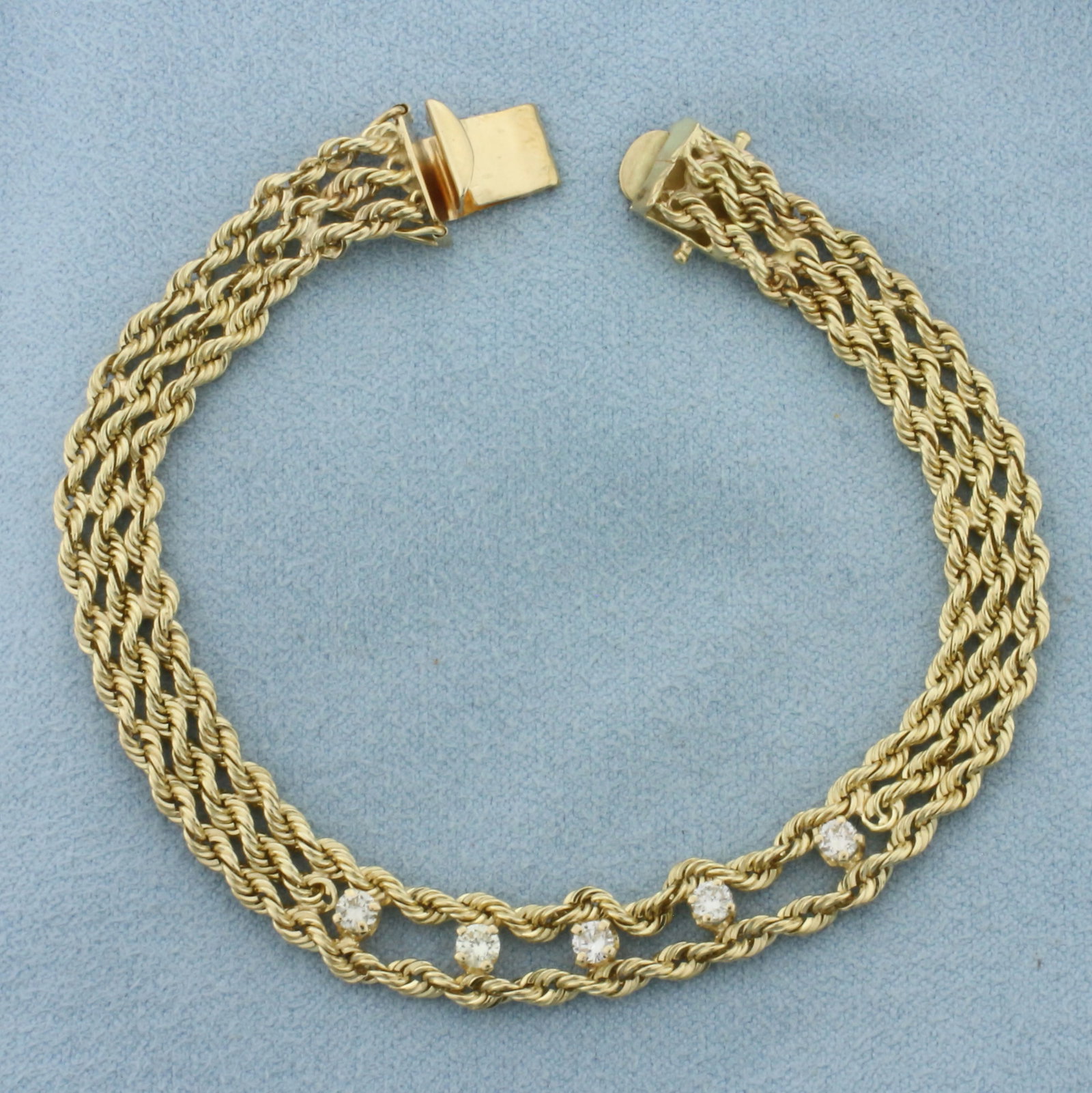 Diamond Triple Rope Bracelet in 14k Yellow Gold: In 14k Yellow Gold. Contains five high quality diamonds, 1/2ct TW, SI clarity/H color. 7 1/8 inches long. 1/4 inch wide. Concealed slide clasp with double safety latch. 12.7g.
