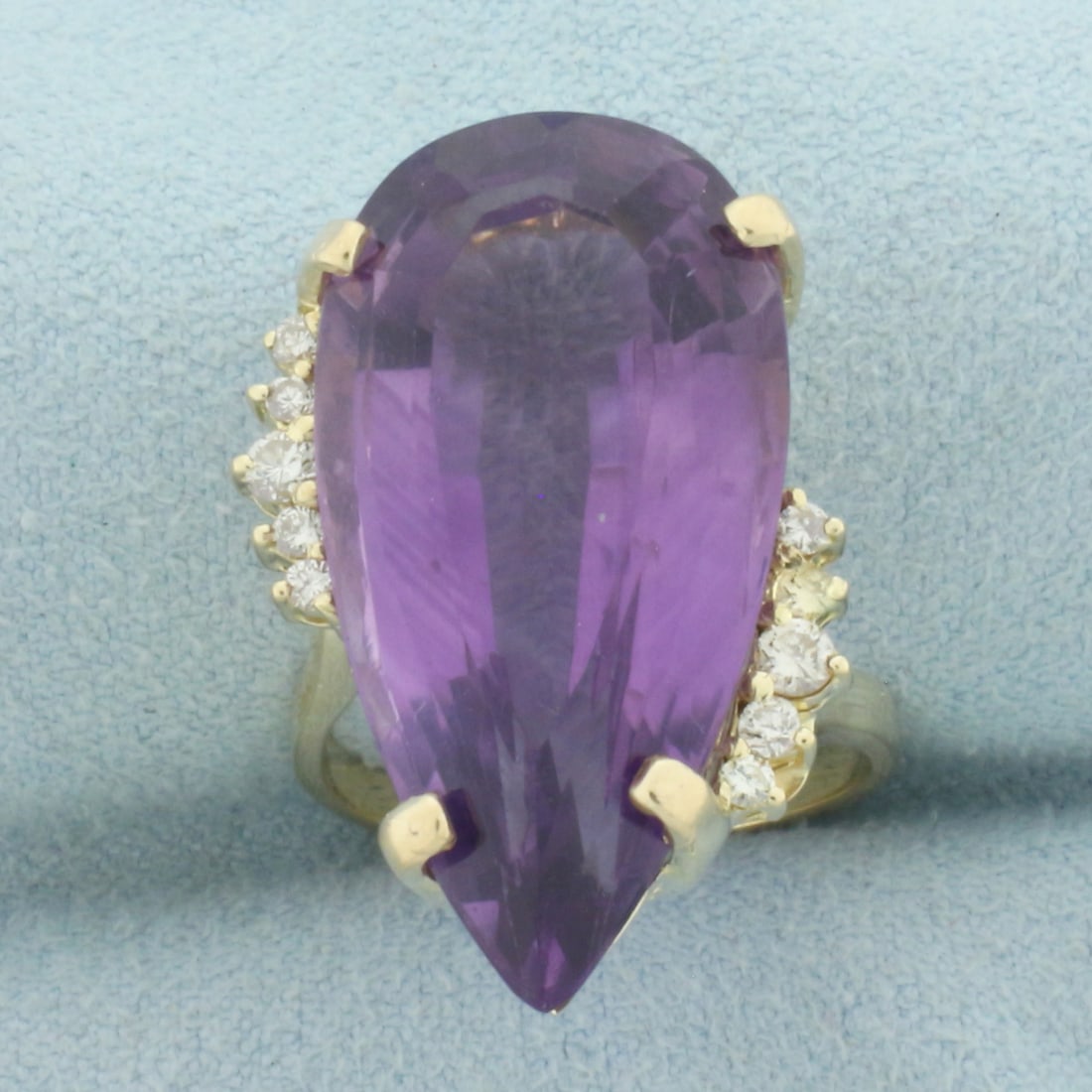 Pear Amethyst and Diamond Statement Ring in 14k Yellow Gold: In 14k Yellow Gold. Contains one 27mm high quality pear cut natural Amethyst gemstone, approximately 16cts, with vibrant color and excellent clarity. Also contains ten high quality diamonds, 1/4ct TW,
