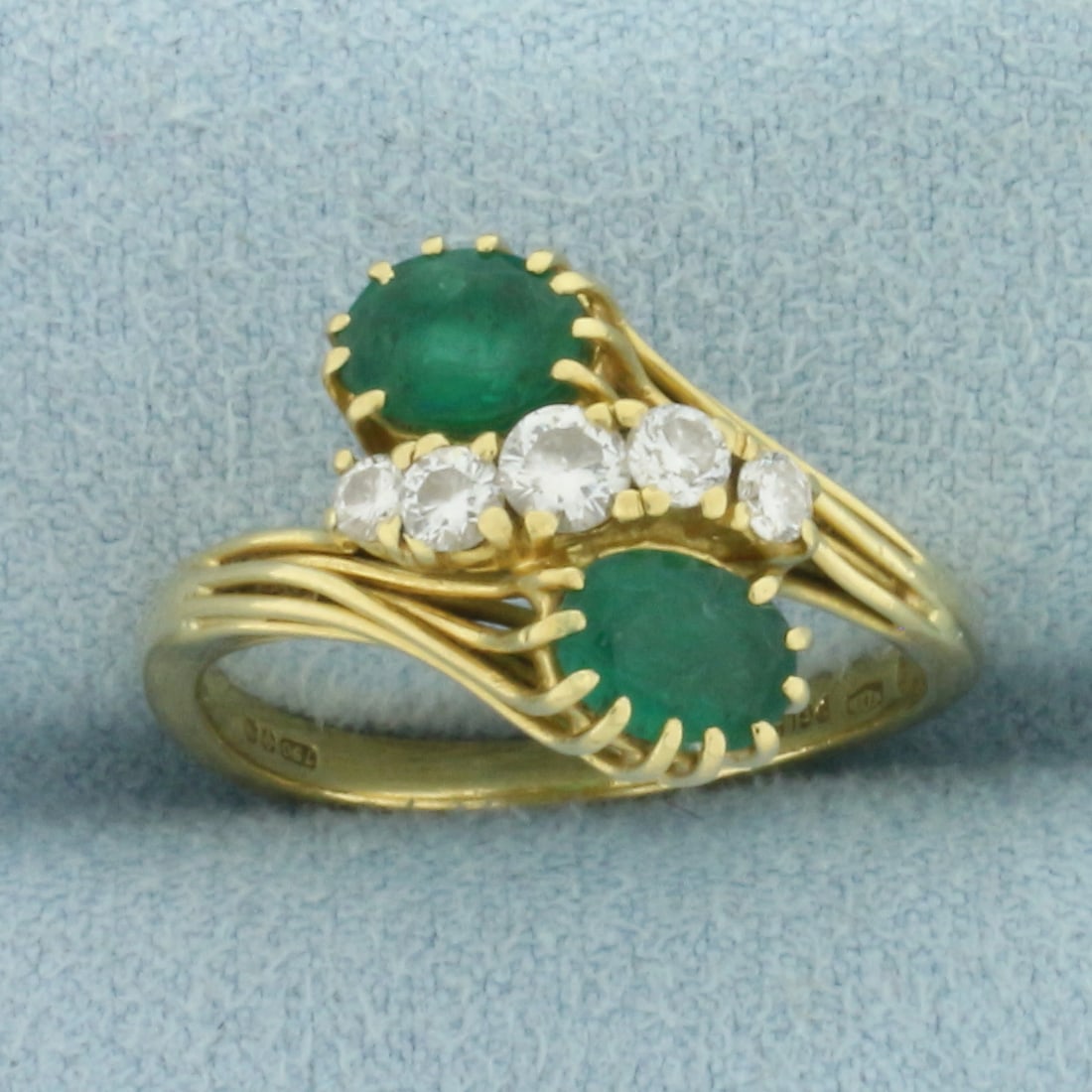 Emerald and Diamond Toi et Moi Ring in 18k Yellow Gold: In 18k Yellow Gold. Contains two 6x4.5mm high quality natural Emerald gemstones, approximately 3/4ct TW, with vibrant color. Also contains five high quality diamonds, 1/3ct TW, VS clarity/G color. 14m