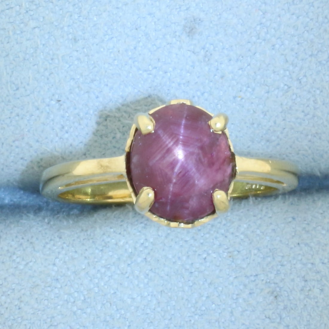 Star Ruby Solitaire Ring in 14k Yellow Gold: In 14k Yellow Gold. Contains one 8x7mm high quality natural Star Ruby gemstone, approximately 3cts, with distinctive "star" under light. Size 5. 3.1g.