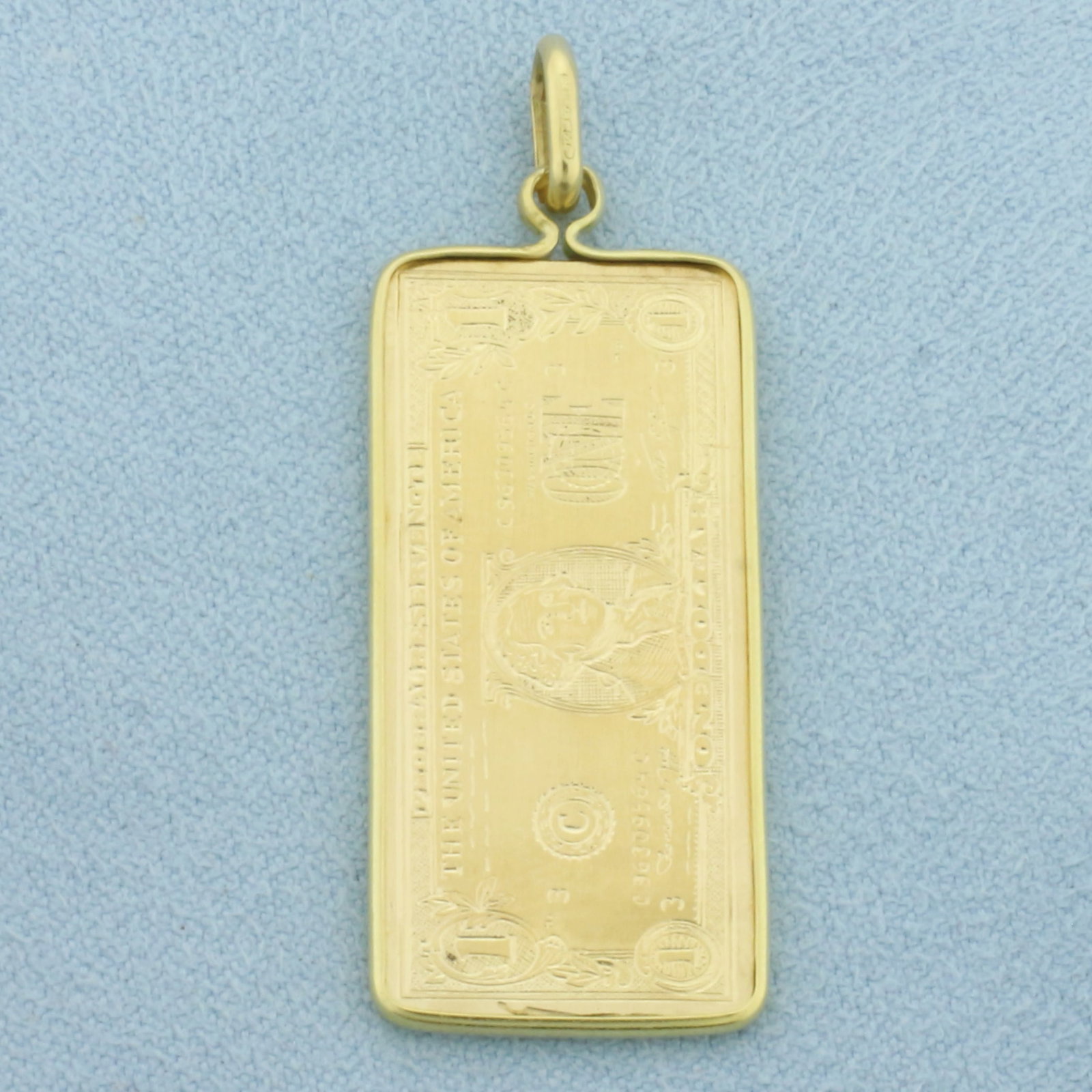 Engraved Dollar Bill Pendant in 18k Yellow Gold: In 18k Yellow Gold. 1 3/4 inch long (including bale). 5/8 inch wide. 5.4g.
