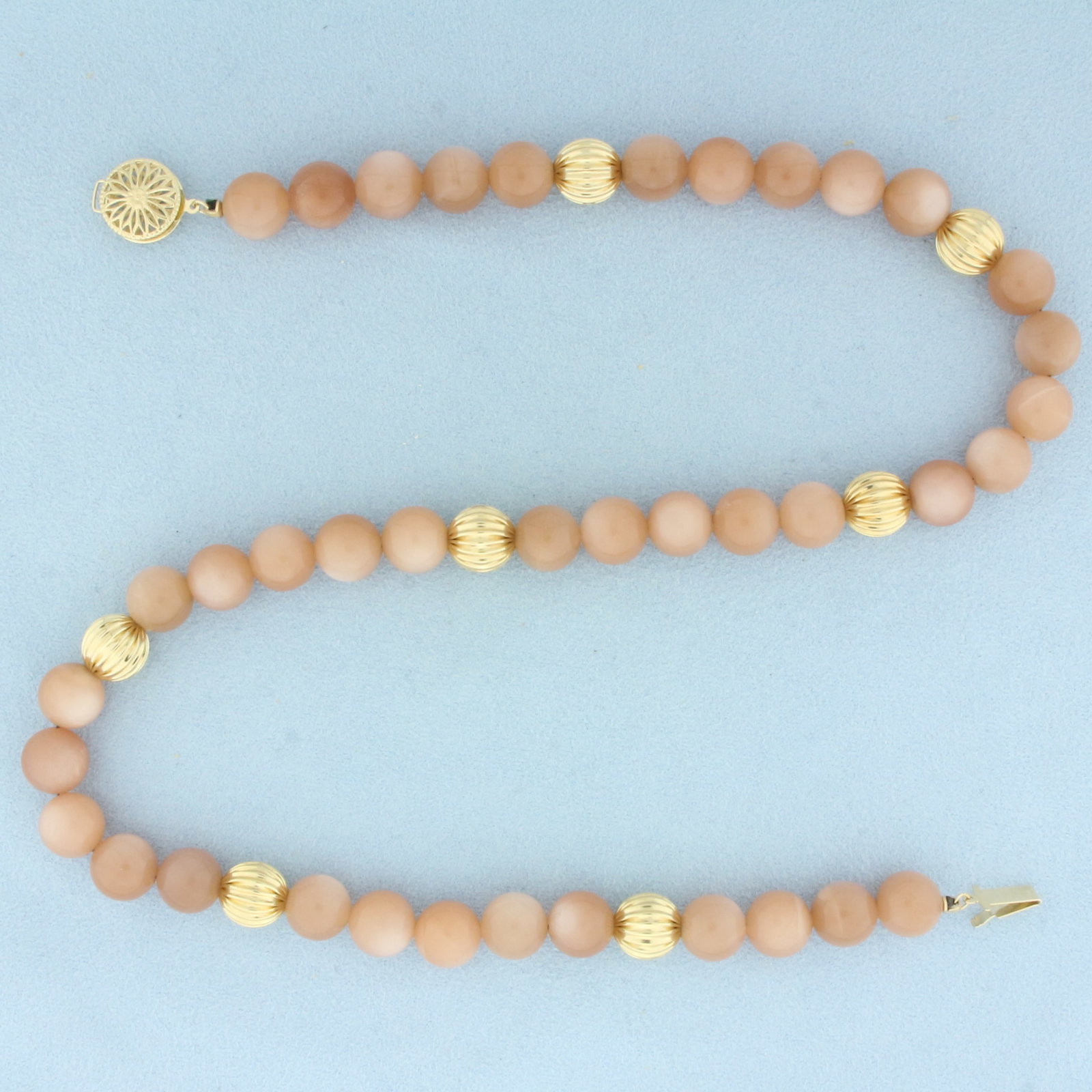 Peach Moonstone and Gold Ball Bead Necklace in 14k Yellow Gold: In 14k Yellow Gold. 19 inches long. 10mm ball beads and high quality moonstone gemstones with beautiful peach color. Decorative filigree clasp.