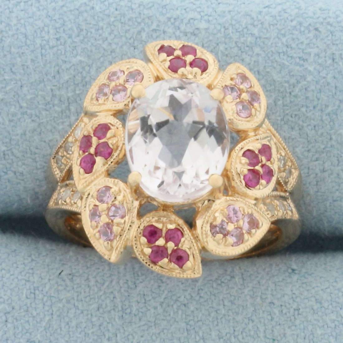 Topaz and Diamond Ring in 14k Rose Gold: In 14k Rose Gold. Contains one 10x8mm White Topaz, sixteen 1.5mm Pink Topaz, and sixteen 1.5mm Salmon Topaz high quality gemstones with vibrant color and excellent clarity. Also contains twelve high q