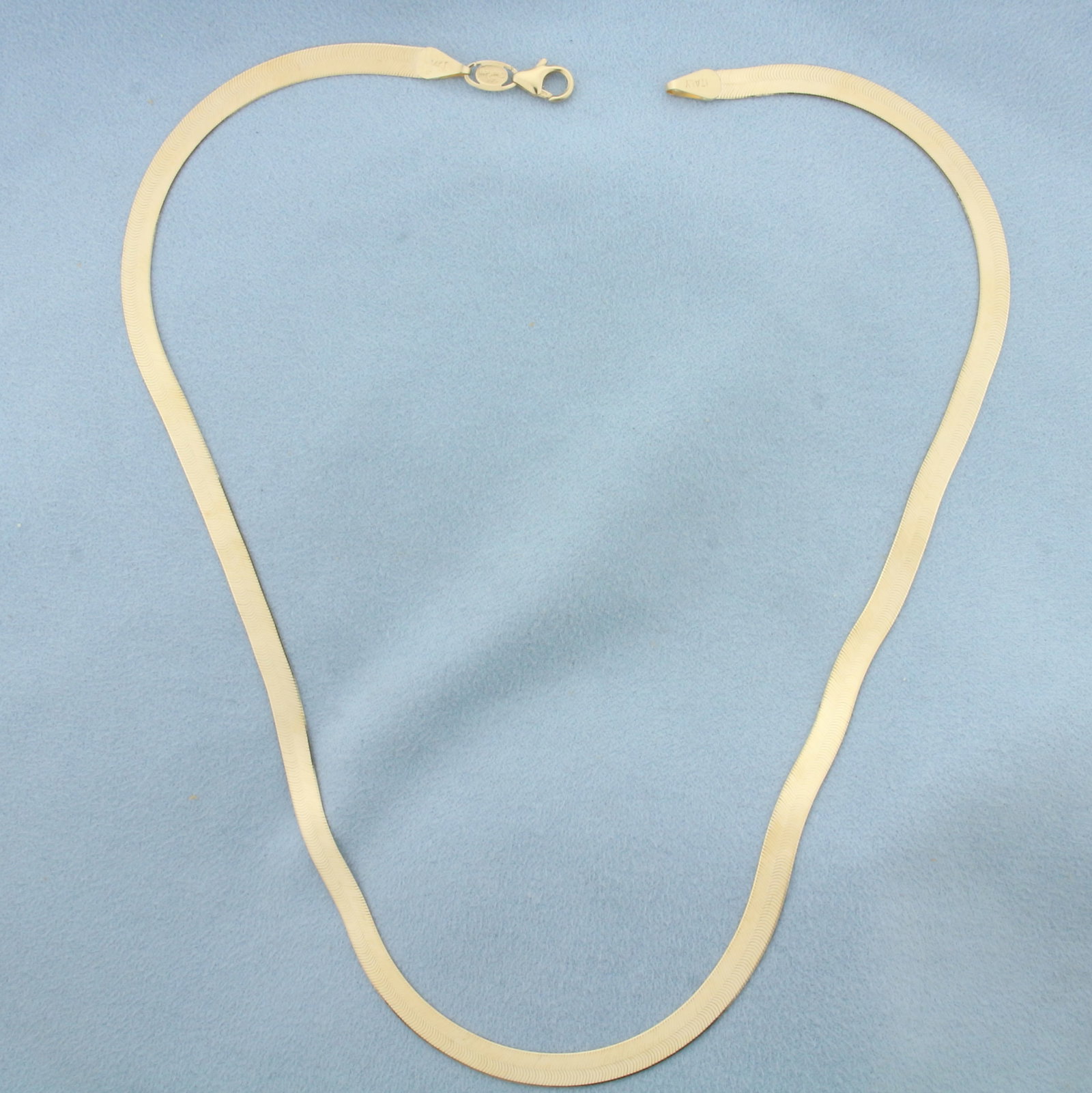 18 Inch Italian Liquid Gold Herringbone Link Chain Necklace in 14k Yellow Gold: In 14k Yellow Gold. 18 inches long. 4.9mm wide. Italian made. Lobster clasp. 9.1g.