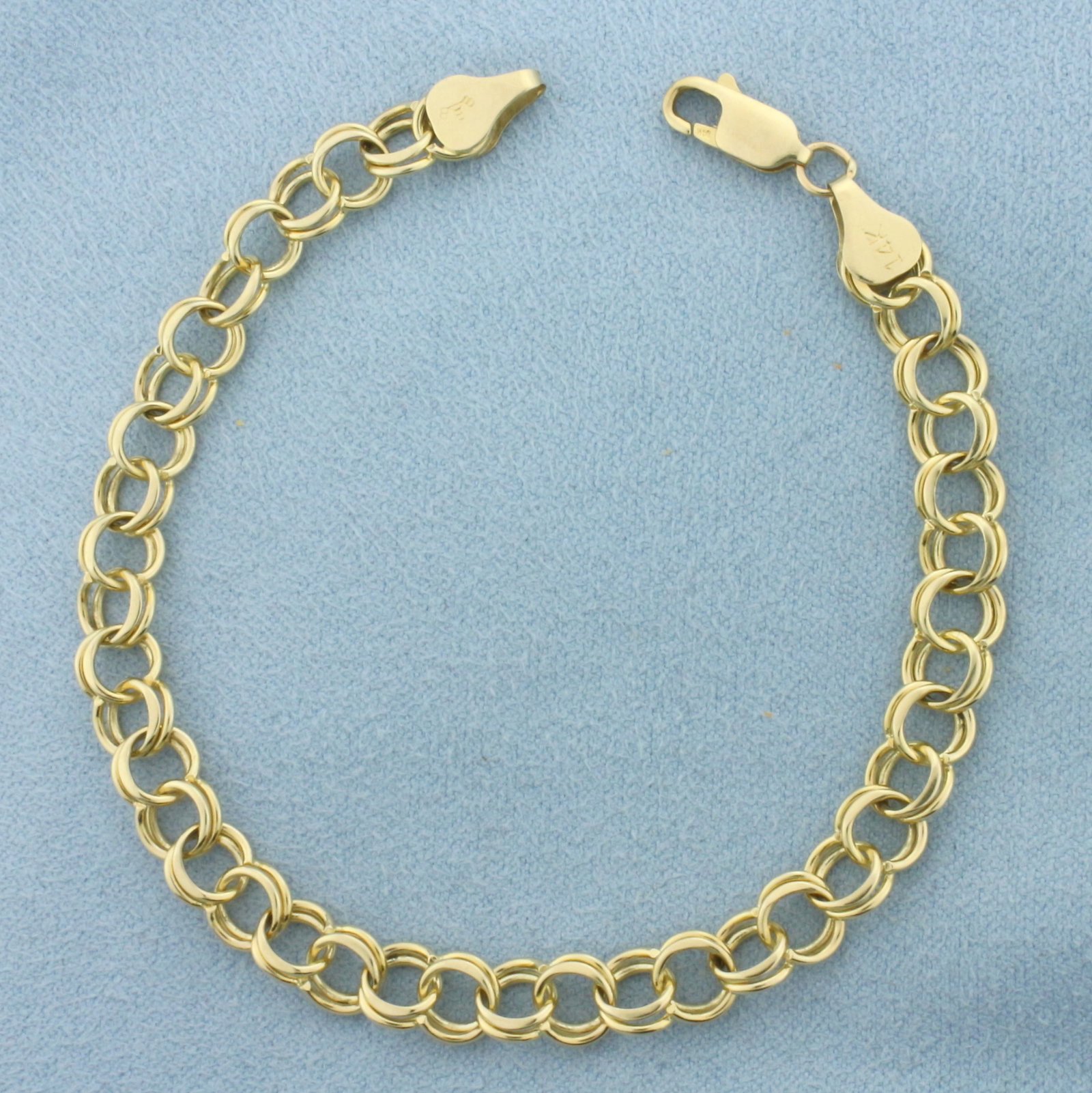 Double Circle Link Charm Bracelet in 14k Yellow Gold: In 14k Yellow Gold. 7 1/2 inches long. 6mm wide. Lobster clasp. 8.8g.