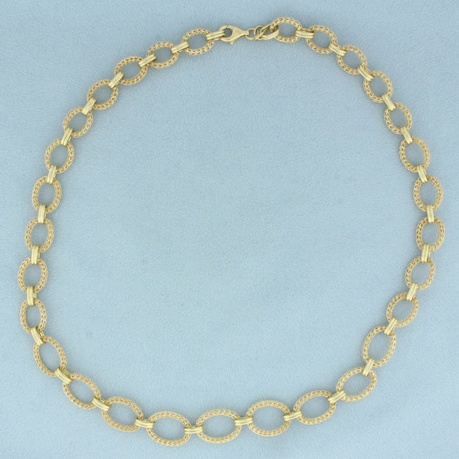 Graduated Mesh Cable Link Chain Necklace in 14K Yellow Gold: In 14k yellow gold. Measures 18 inches long by 12mm wide (at widest). Tapers to 9mm wide. Lobster clasp. 14.2g