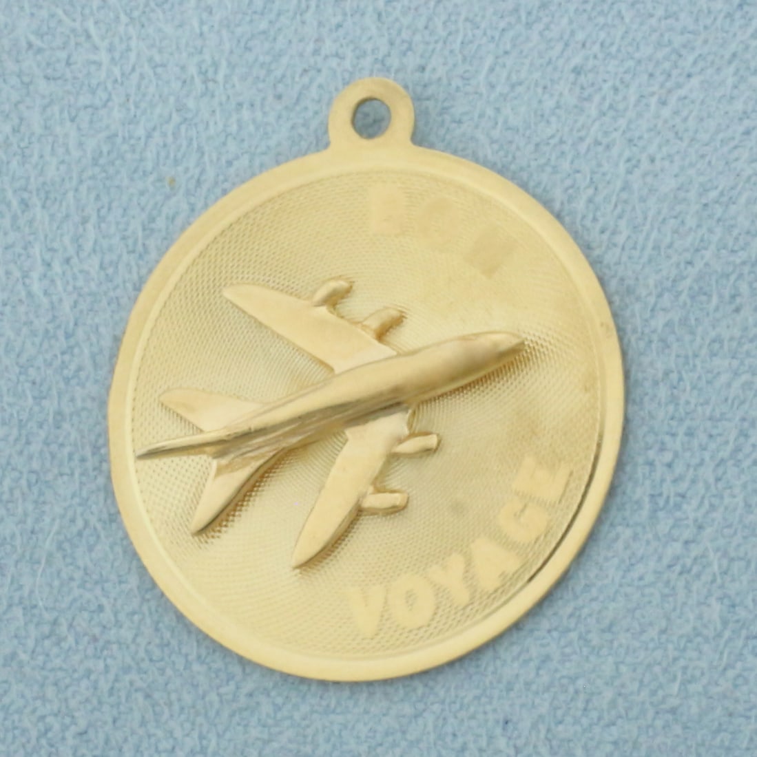 Engravable Bon Voyage Plane Medallion Charm or Pendant in 14k Yellow Gold: In 14k Yellow Gold. 1 inch long. 7/8 inch wide. Blank back to engrave name or date. 2.7g.