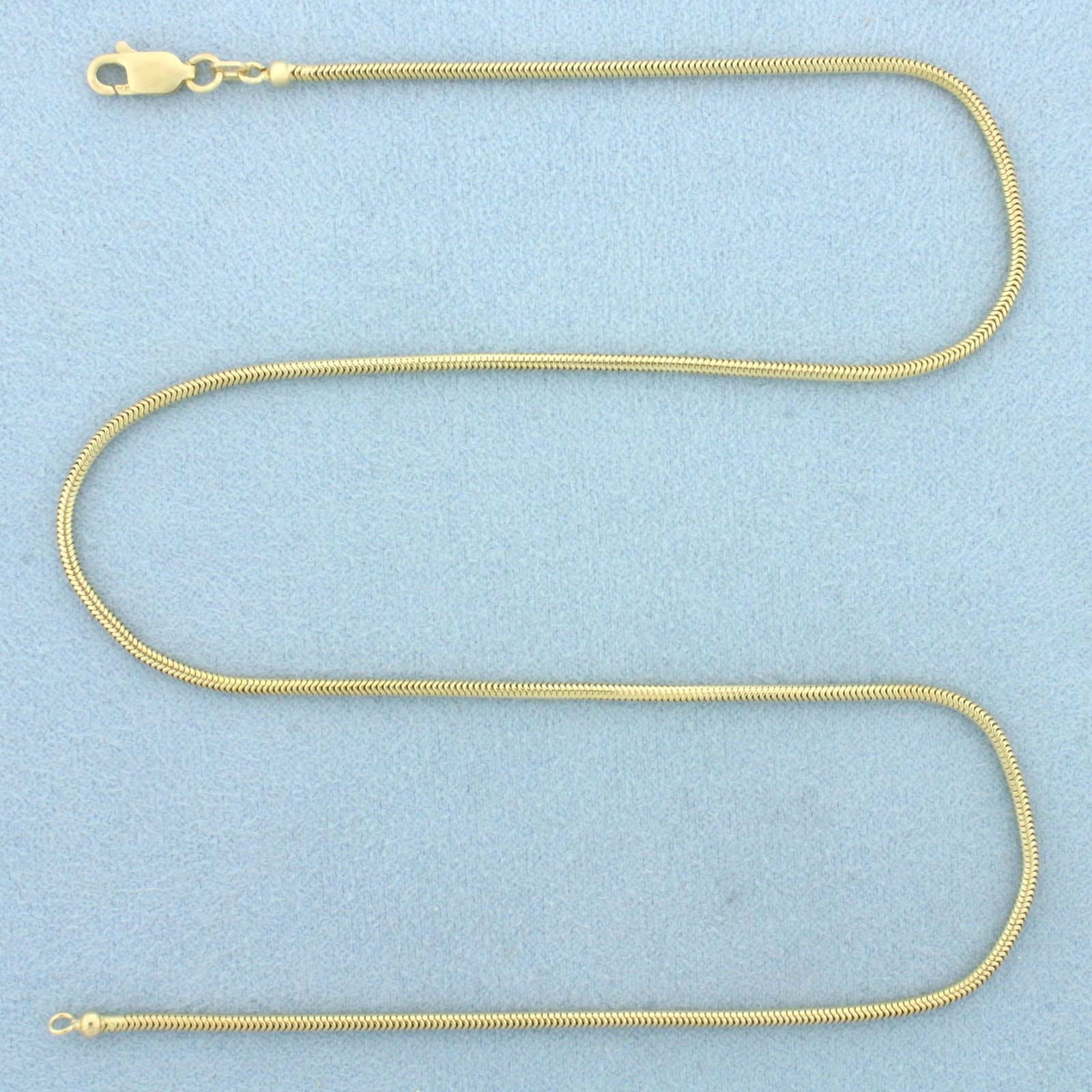 16 Inch Italian Snake Link Necklace in 14k Yellow Gold: In 14k Yellow Gold. 16 inches long. 1.6mm wide. Italian made. Lobster clasp. 6.0g.