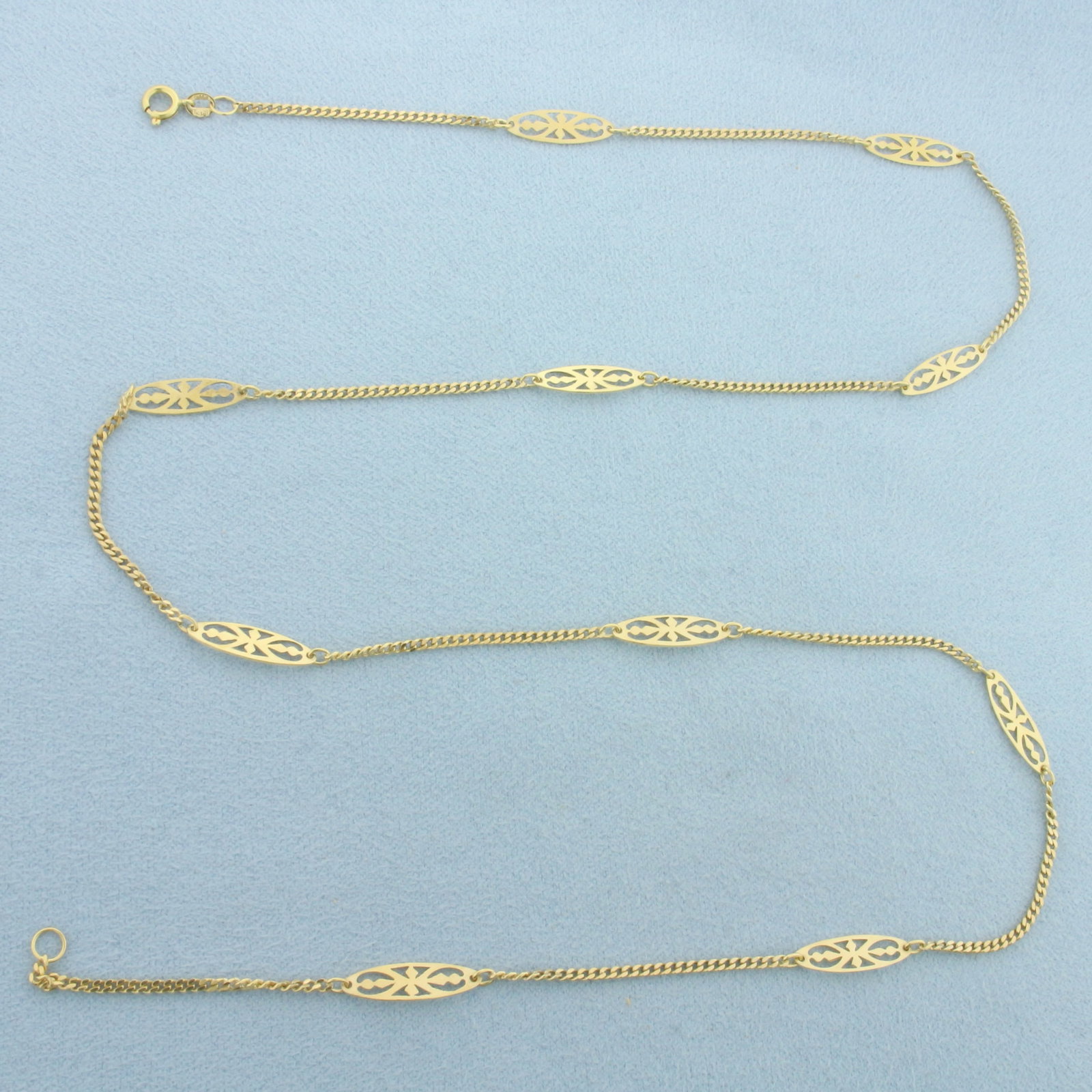 Filigree Station Link Necklace in 18k Yellow Gold: In 18k Yellow Gold. 22 inches long. 4.3mm wide at widest point. Spring clasp. 5.5g.