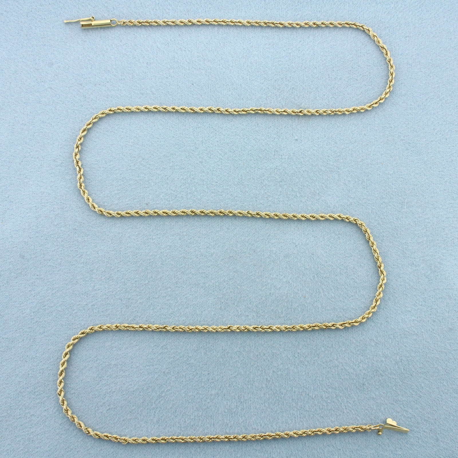 20 Inch Rope Link Chain Necklace in 14k Yellow Gold: In 14k Yellow Gold. 20 inches long. 2mm wide. Barrel clasp with safety latch. 6.8g.