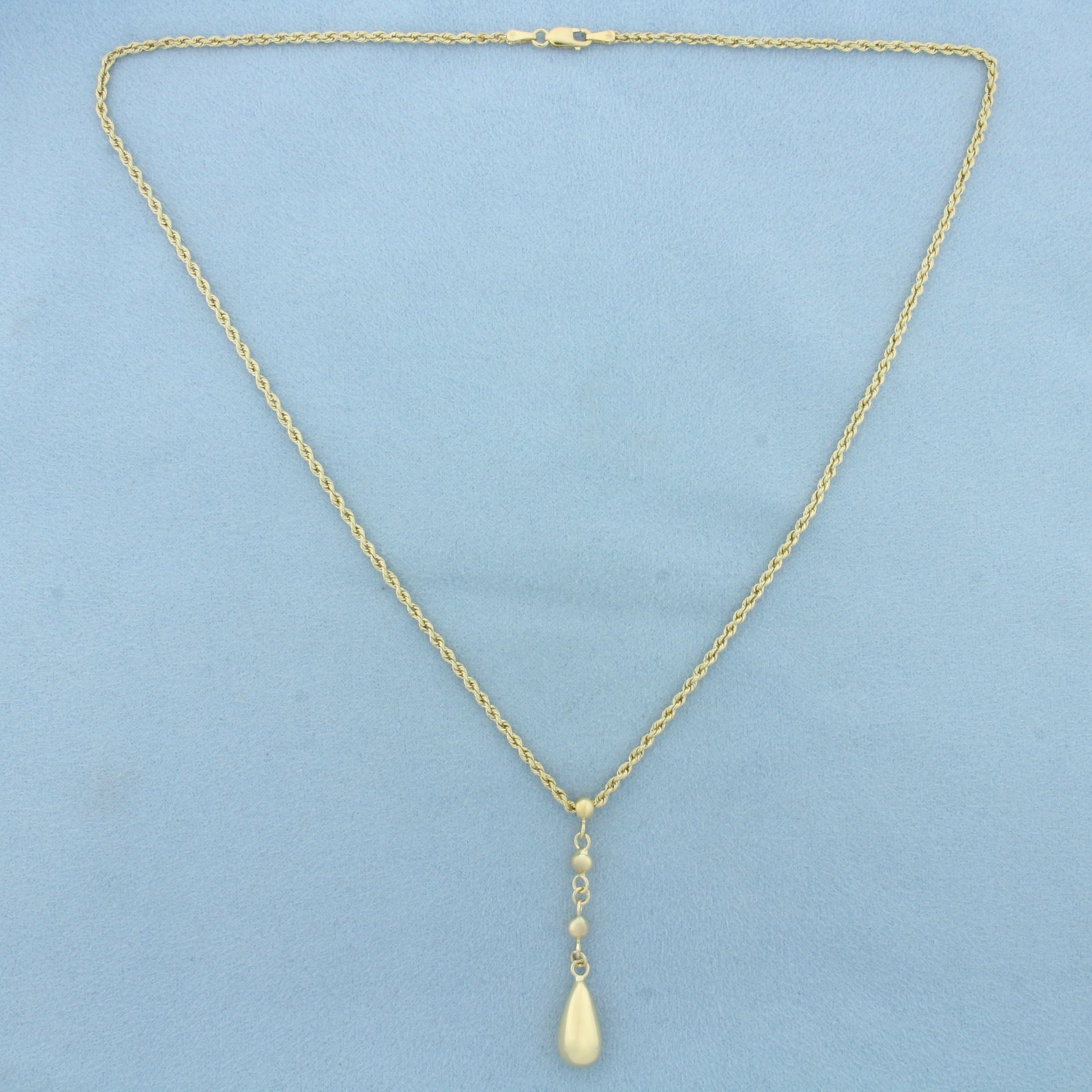 Teardrop Drop Dangle Rope Necklace in 14k Yellow Gold: In 14k Yellow Gold. Rope link chain is 18 inches long, 2mm wide. Teardrop dangle is 1 3/4 inch by 1/4 inch. Lobster clasp. 3.5g.