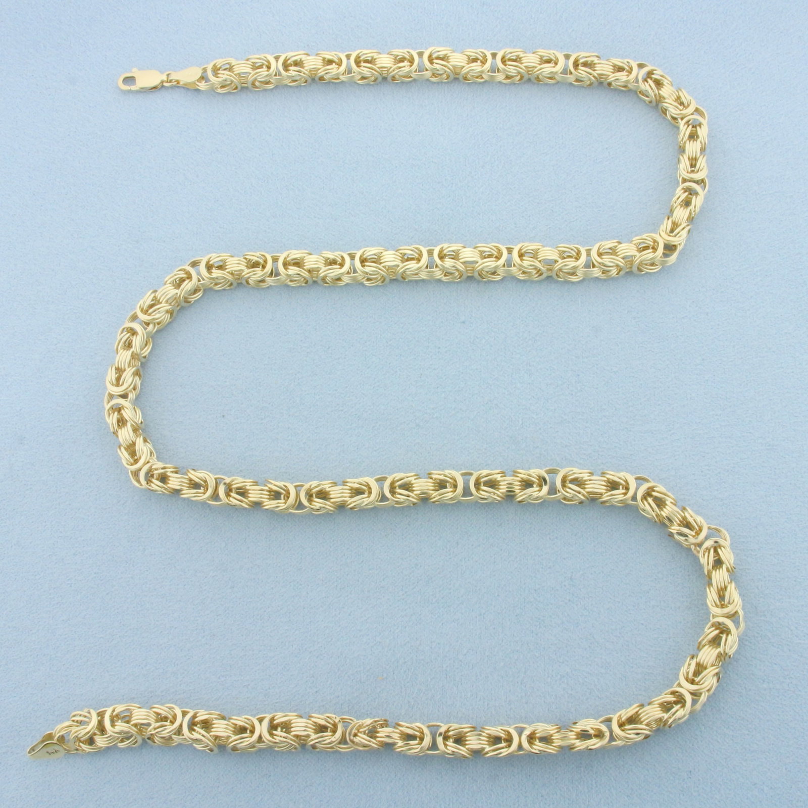 21 Inch Byzantine Link Chain Necklace in 14k Yellow Gold: In 14k Yellow Gold. 21 inches long. 5.5mm wide. Lobster clasp. 13.2g.