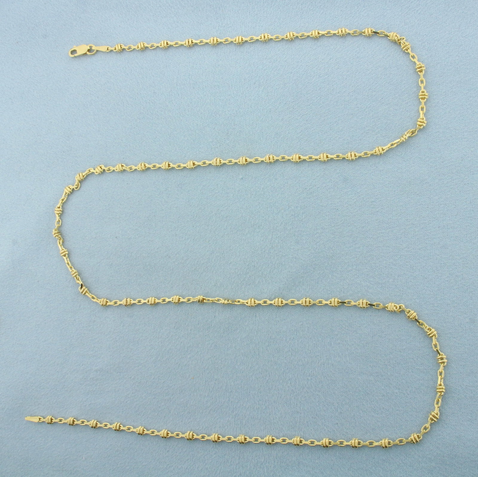 24 Inch Italian Knot Link Chain Necklace in 14k Yellow Gold: In 14k Yellow Gold. 24 inches long. 3.1mm wide. Italian made. Lobster clasp. 10.8g.