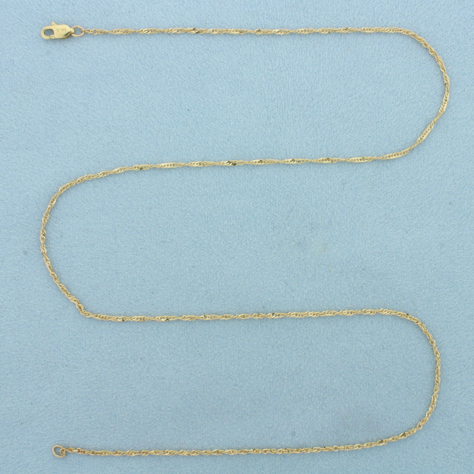 18 Inch Twisting Curb Link Chain Necklace in 14k Yellow Gold: In 14k Yellow Gold. 18 inches long. 1.3mm wide. Lobster clasp. 2.0g.
