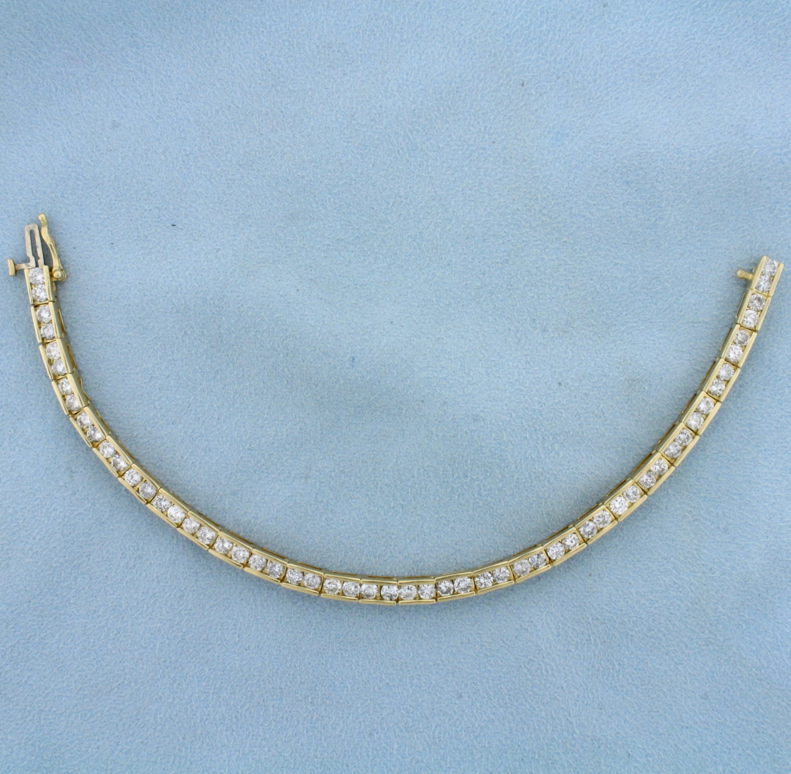 Channel Set 6ct Diamond Line Tennis Bracelet in 14k Yellow Gold: In 14k yellow gold. Contains fifty six high quality diamonds, 6ct TW, I1 clarity/H color, eye clean, great cut for added brilliance. 7 inches long, with safety clasp. 16.3g.