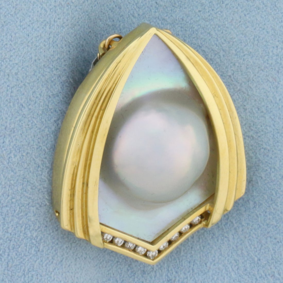 Designer Mabe Pearl and Diamond Statement Pendant in 18k Yellow Gold: In 18K Yellow Gold. Contains one high quality natural Mabe Pearl on Mother of Pearl with significant iridescence and beautiful silver color. Also contains nine high quality .02 ct diamonds, VS clarity