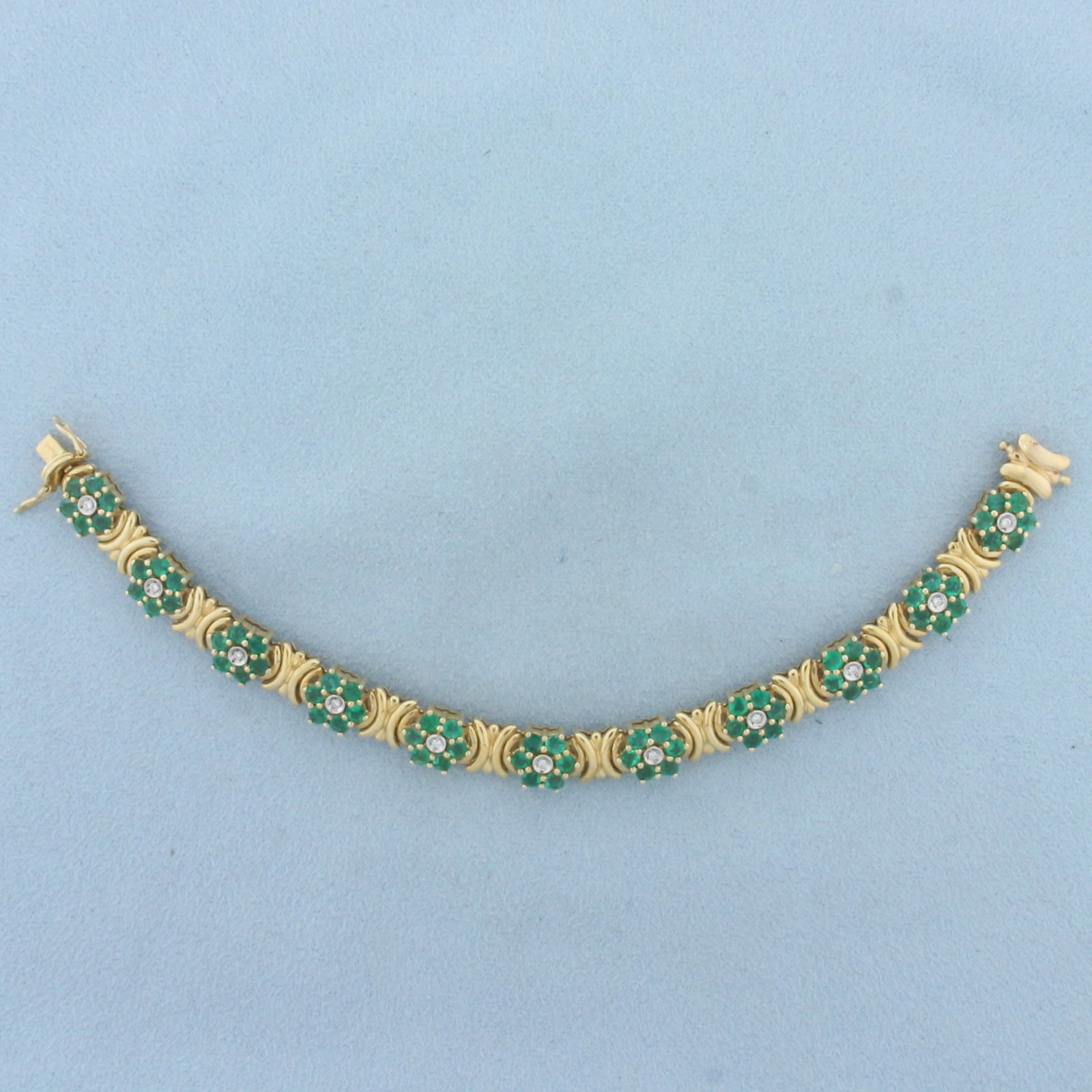 Vintage Emerald and Diamond Flower Design Bracelet in 14k Yellow Gold: In 14k yellow gold. Contains 66 high quality natural emeralds, approximately 5.5ct TW, with vibrant green color. Also contains 11 high quality .01ct diamonds, SI clarity/H color. 6 inches long, 8.5mm 