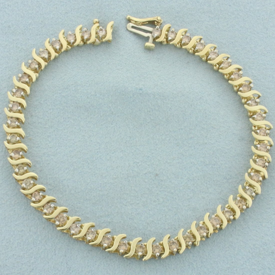 Champagne Diamond Tennis Bracelet in 10k Yellow Gold: In 10k yellow gold. Contains 43 high quality champagne diamonds, 3ct TW, with warm color and excellent clarity. 7 1/4 inches long and 5.2mm wide. Safety clasp. 8.8g.