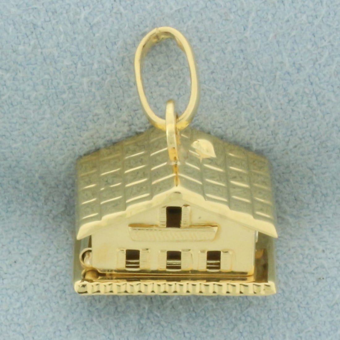 Heart Home Mechanical Pendant in 18k Yellow Gold: In 18k yellow gold. Home opens up to show two hearts. 1/2 inches long and 3/8 inches wide closed, 1 inch long opened. 2.8g.