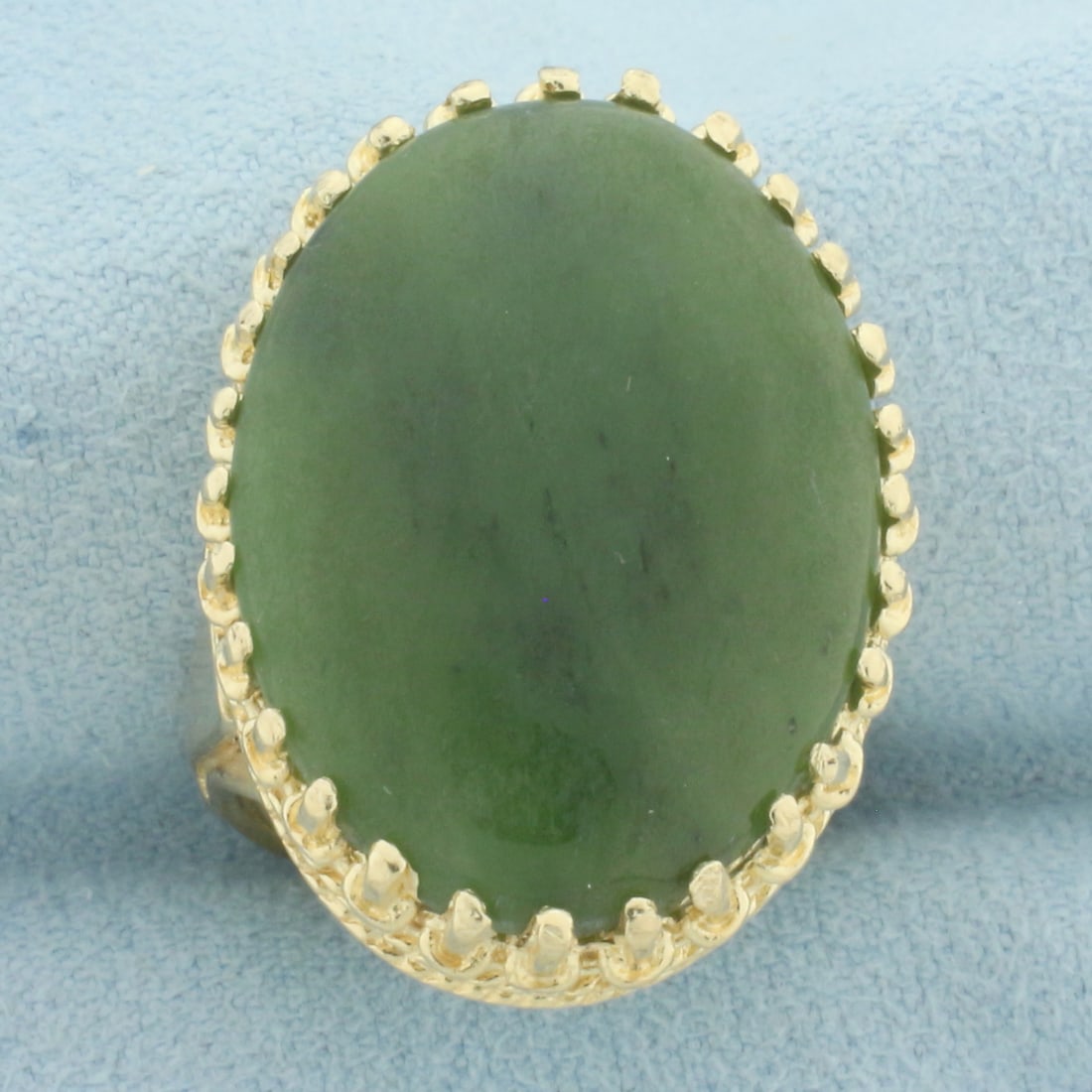Crown Set Jade Statement Ring in 14k Yellow Gold: In 14k yellow gold. Contains one high quality natural 25mm by 18mm Jade gemstone with uniform color and excellent clarity. Size: 6. 10.9g.