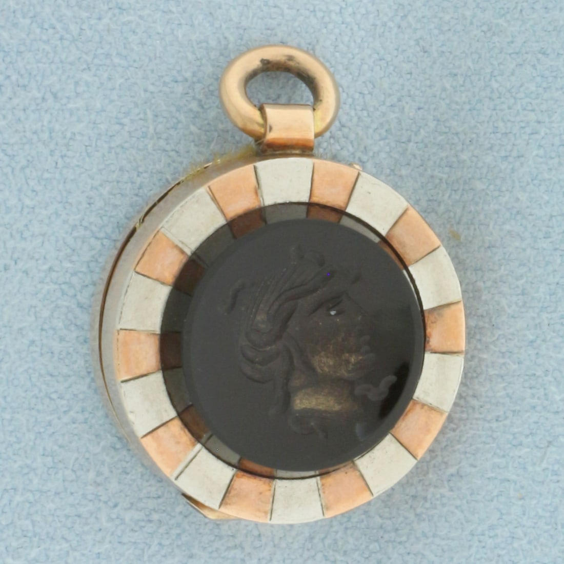Antique Mourning Hair Locket Charm or Pendant in 10k Rose and White Gold: In 10k Rose and White Gold. 14.5mm carved onyx cameo. 1 inch long. 3/4 inch wide. Hand engraved back. Opens to reveal hair behind glass. 6.3g.
