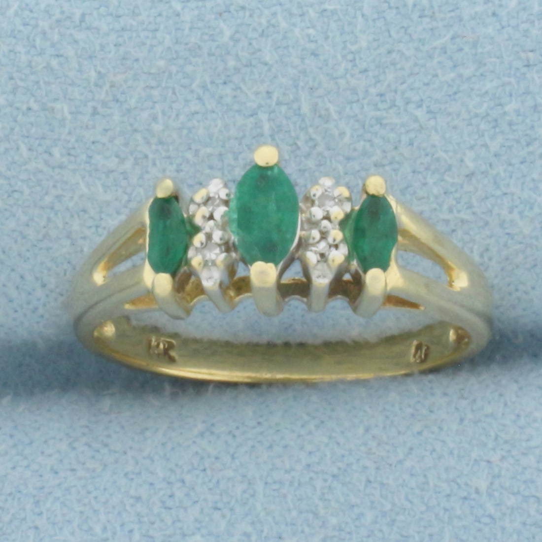 Emerald and Diamond Ring in 14k Yellow Gold: In 14k Yellow Gold. Contains one 6mm and two 4mm marquise cut high quality natural Emerald gemstones with vibrant color. Emeralds do have chipping on sides, does not take away from beauty of ring. Als