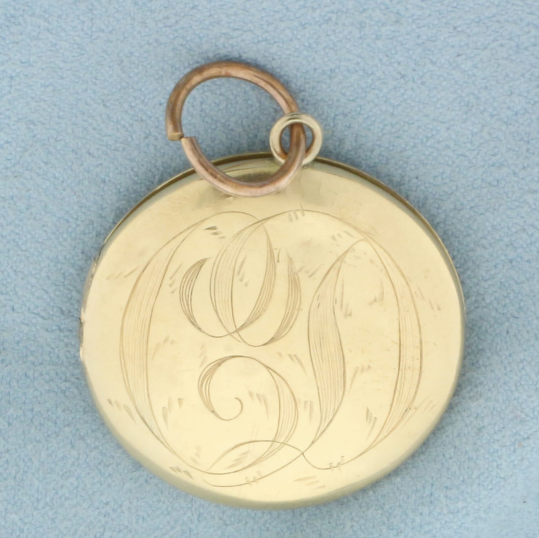 Antique Engraved Locket in 14k Yellow Gold: In 14k Yellow Gold. 1 1/8 inch diameter. Hand engraved. Minor denting, indicative of age. 6.3g.