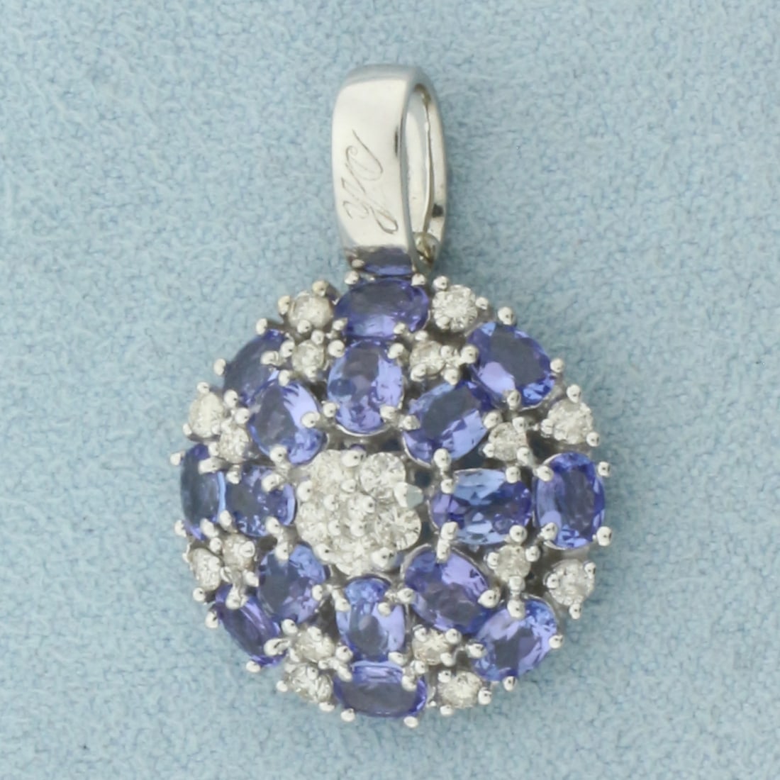 AAA Tanzanite and Diamond Pendant in 18k White Gold: In 18k White Gold. Contains 22 high quality diamonds, 1/2ct TW, VS clarity/G color. Also contains sixteen 4mm AAA quality oval natural Tanzanite gemstones, with vibrant color and excellent clarity. 1 