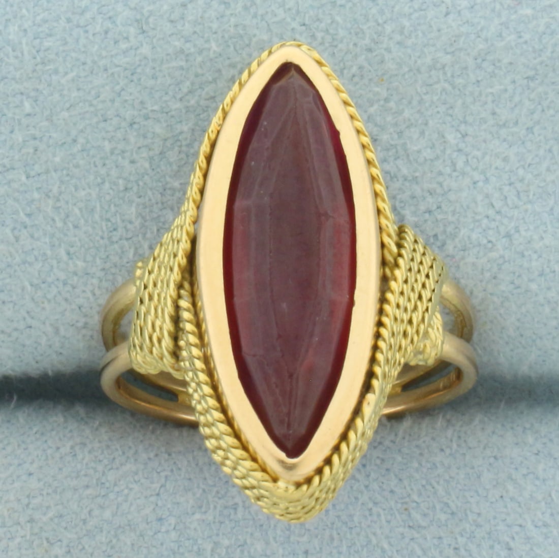 Vintage Lab Ruby Navette Ring in 18k Yellow Gold: In 18k Yellow Gold. Contains one 21x7mm high quality elongated marquise cut Lab created Ruby gemstone, approximately 7cts, with vibrant color and excellent clarity. Size 5.5. 7.5g.