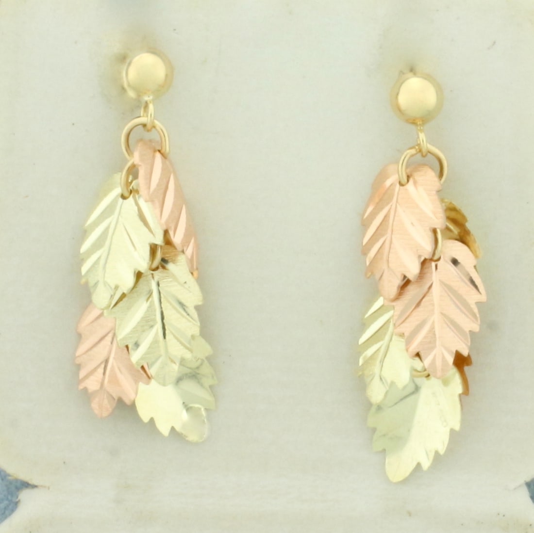 Leaf Dangle Earrings in 14k Yellow and Rose Gold: In 14k Yellow and Rose Gold. 1 inch long. 3/8 inch wide. Friction backs. 3.1g.
