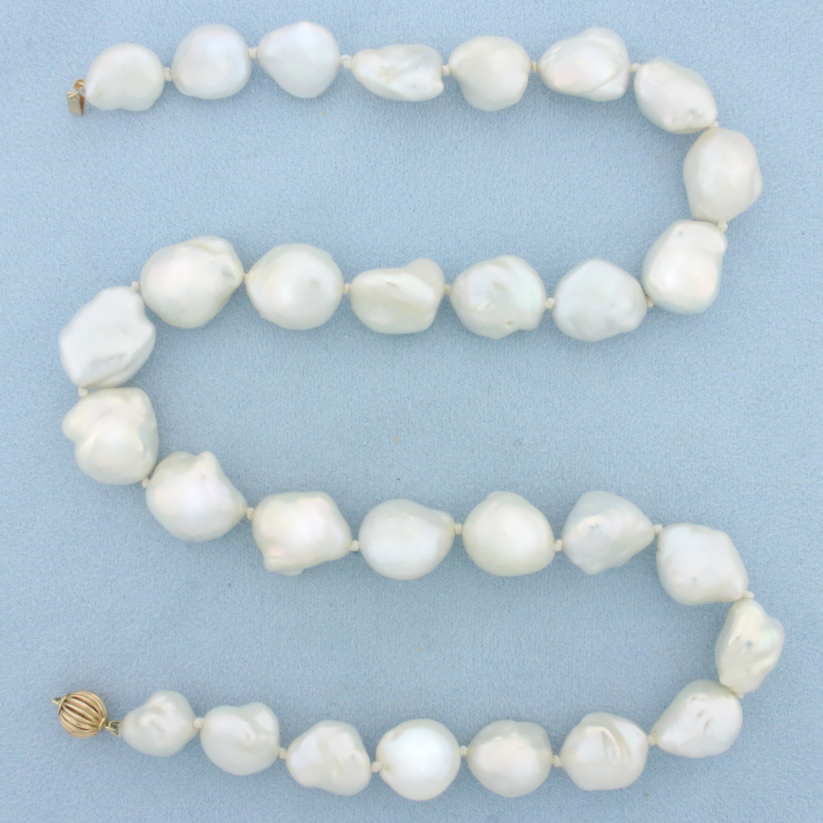 Hand Knotted Large Baroque Pearl Strand Necklace: 14k Yellow Gold Clasp. Contains 30 large 13 to 16mm Baroque Freshwater Pearls with high luster. 20 inches long. Hand knotted. Decorative scalloped gold bead clasp. 52.3g.
