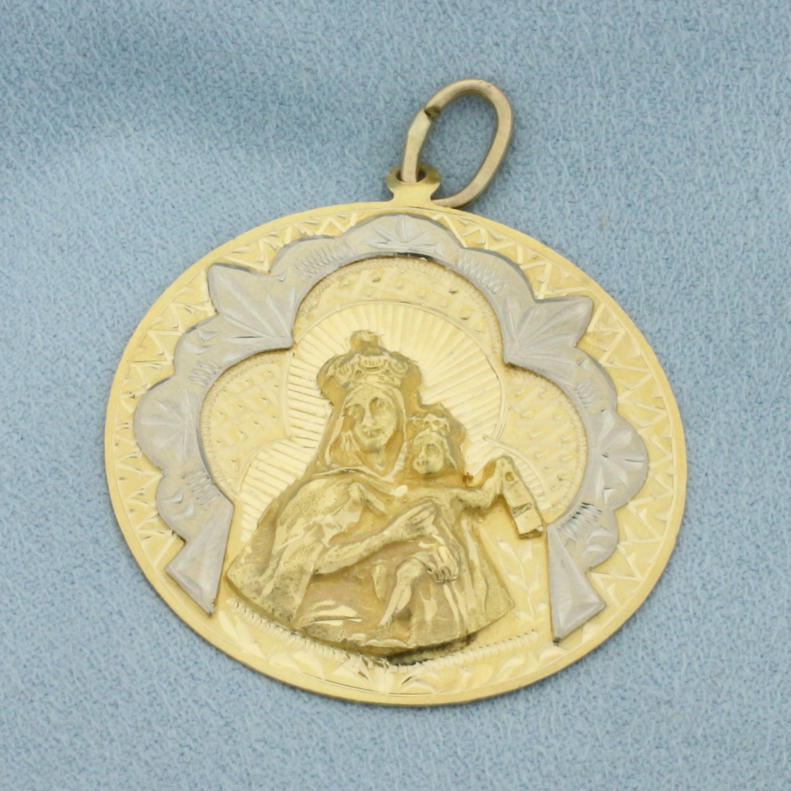 Carmine Madonna Medal Virgin Mary and Baby Jesus Pendant in 18k Yellow Gold: In 18k Yellow Gold with 18k White Gold Accents. 1 7/8 inch long (including jump ring). 1 1/2 inch wide. 10.6g.
