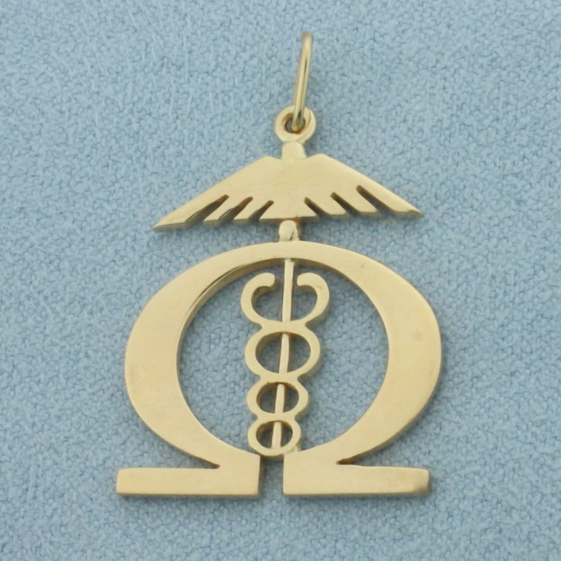 Caduceus Omega Wings Charm or Pendant in 14k Yellow Gold: In _k Yellow Gold. 1 1/4 inch long (including jump ring). 3/4 inch wide. 3.8g.