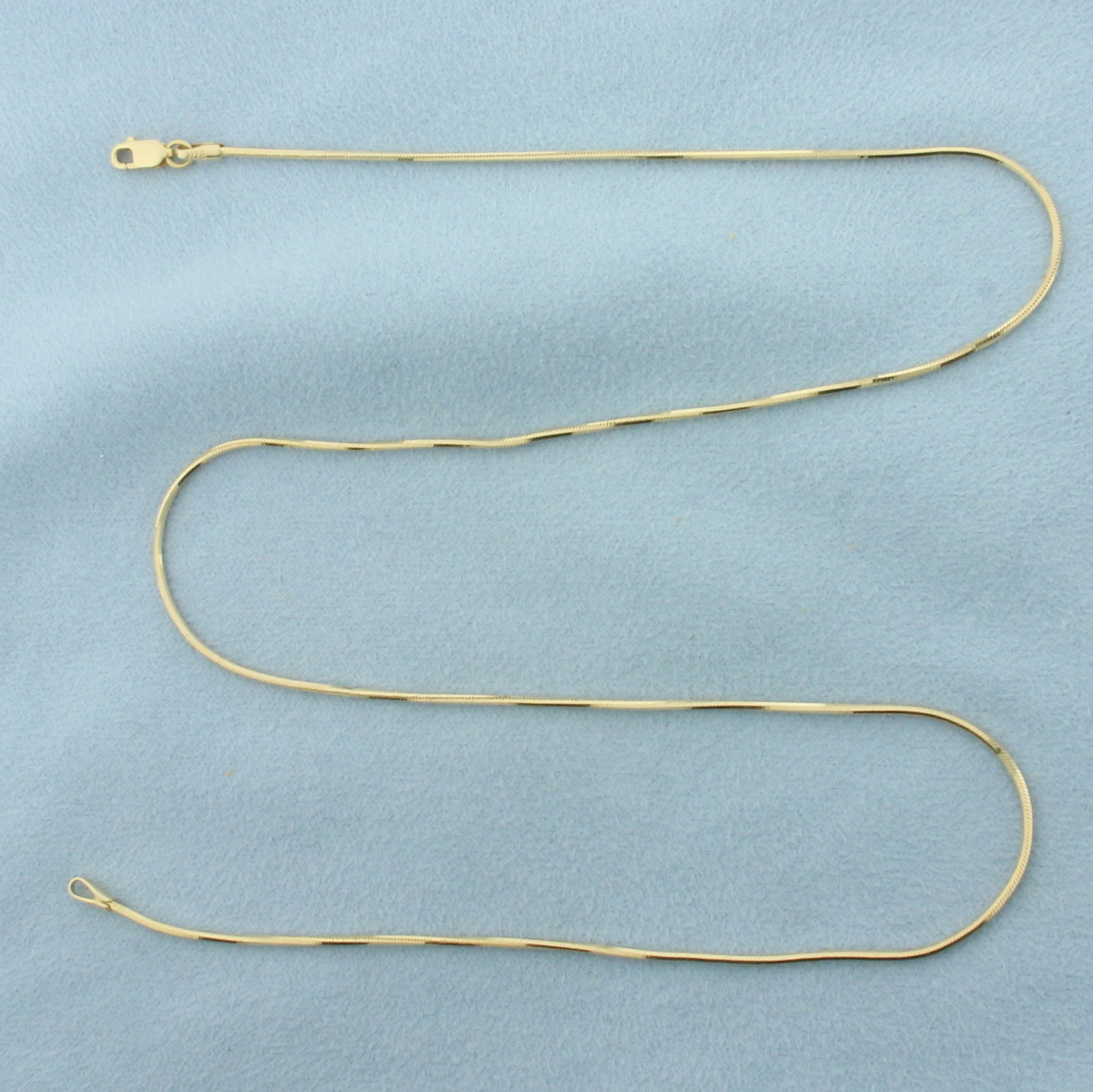 18 Inch Italian Snake Link Chain Necklace in 14K Yellow Gold: In 14k yellow gold. Italian made. Measures 18 inches long by 1mm wide. Lobster clasp. 4.5g